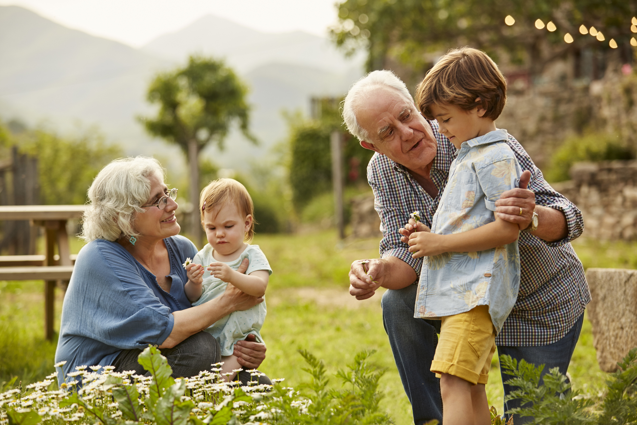Grandparents playing with their grandchildren outside | Source: Getty Images