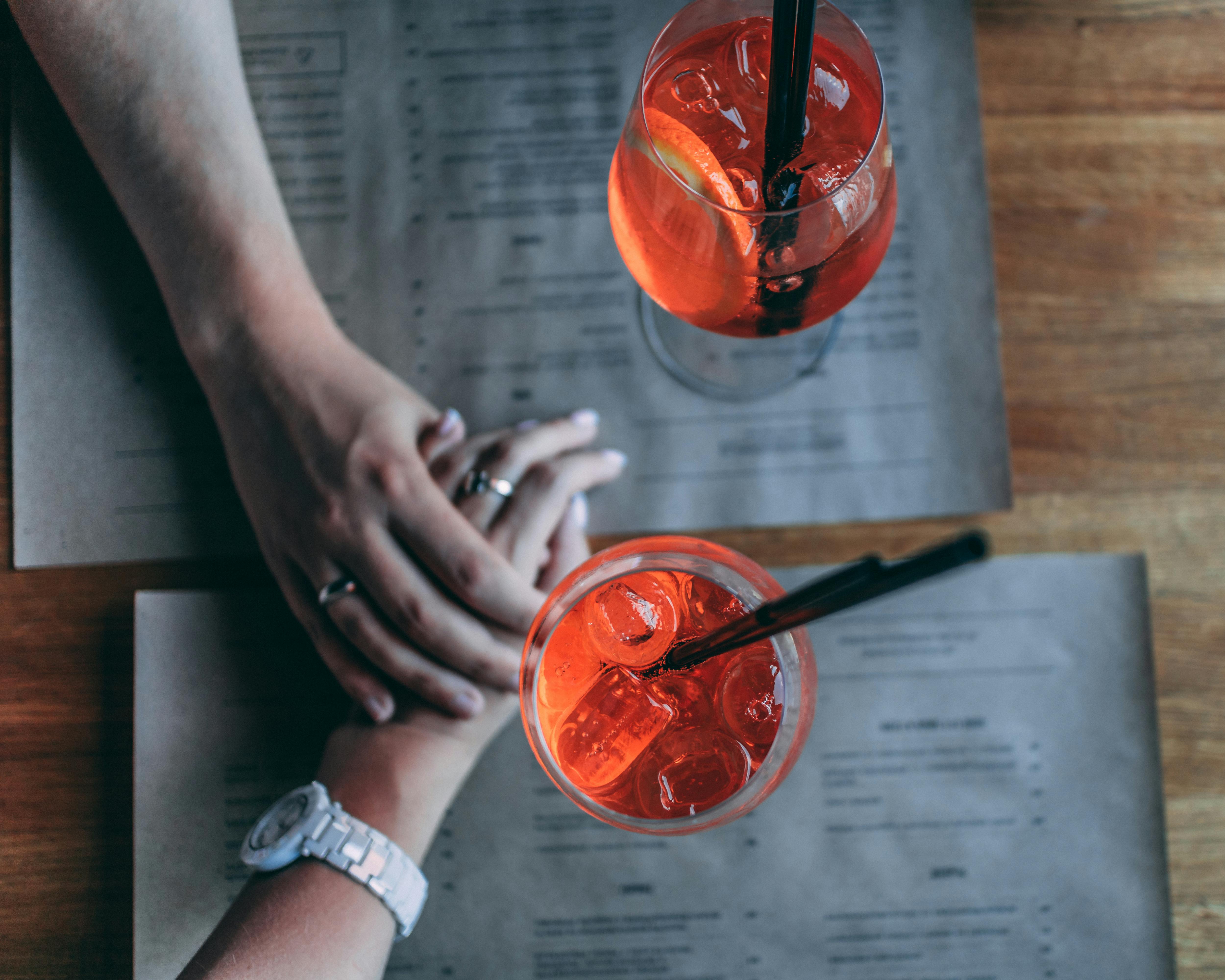 A couple holding hands across a restaurant table | Source: Pexels
