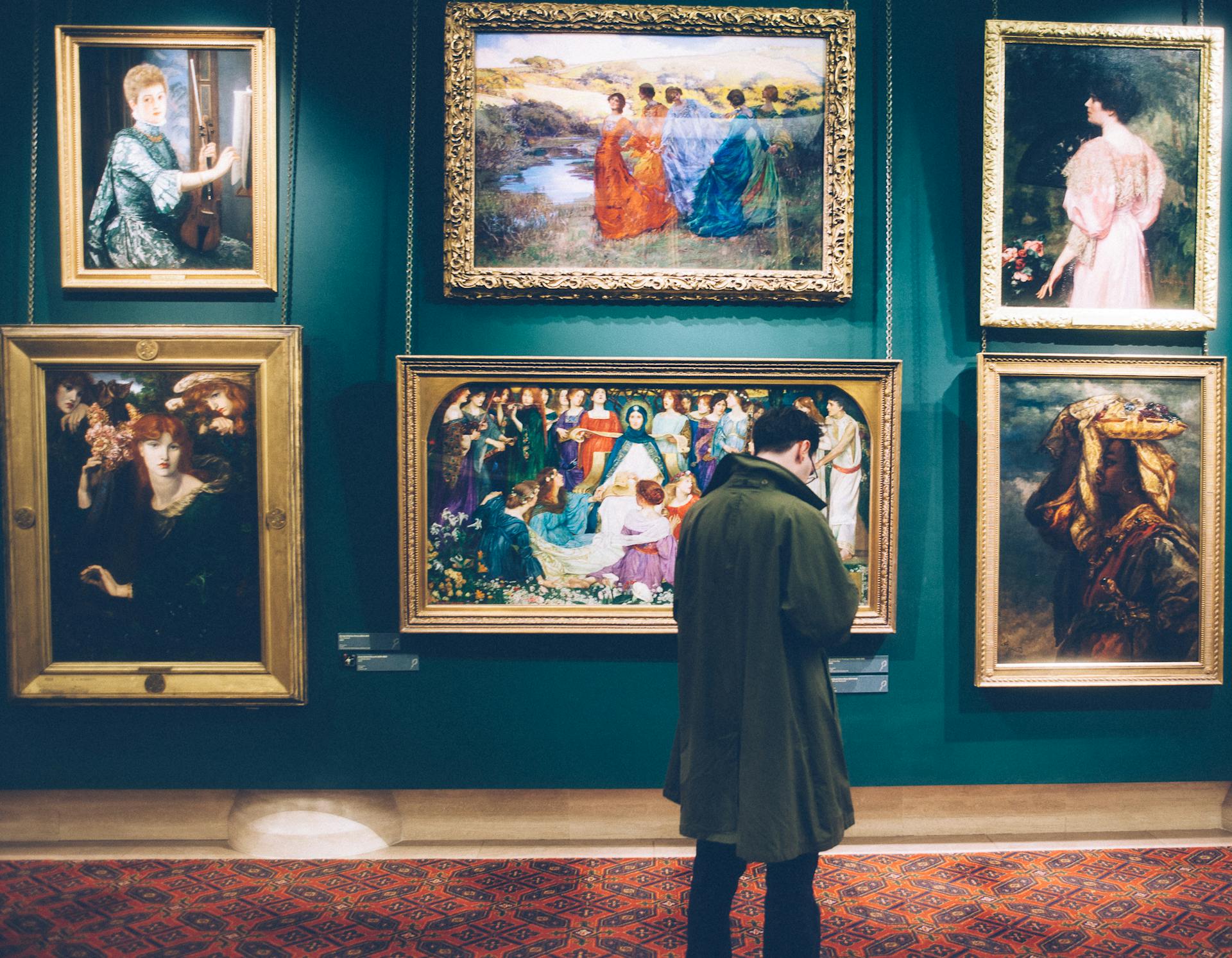 A man standing in front of paintings | Source: Pexels