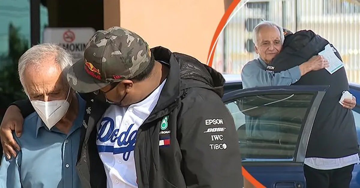 A man hugs his former student who helped raise money for him after seeing that he lived in his car | Photo: Youtube/FOX 11 Los Angeles