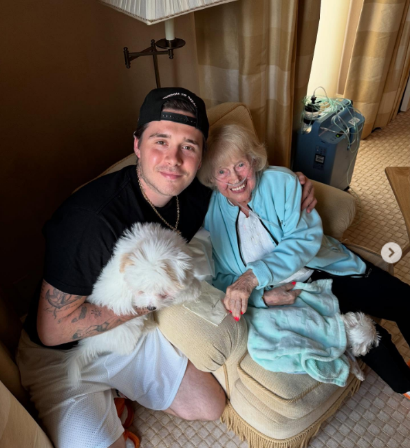 Brooklyn Beckham and Nicola Peltz's grandmother, Naunni, pose together on a sofa in a post dated May 16, 2025 | Source: Instagram/brooklynpeltzbeckham