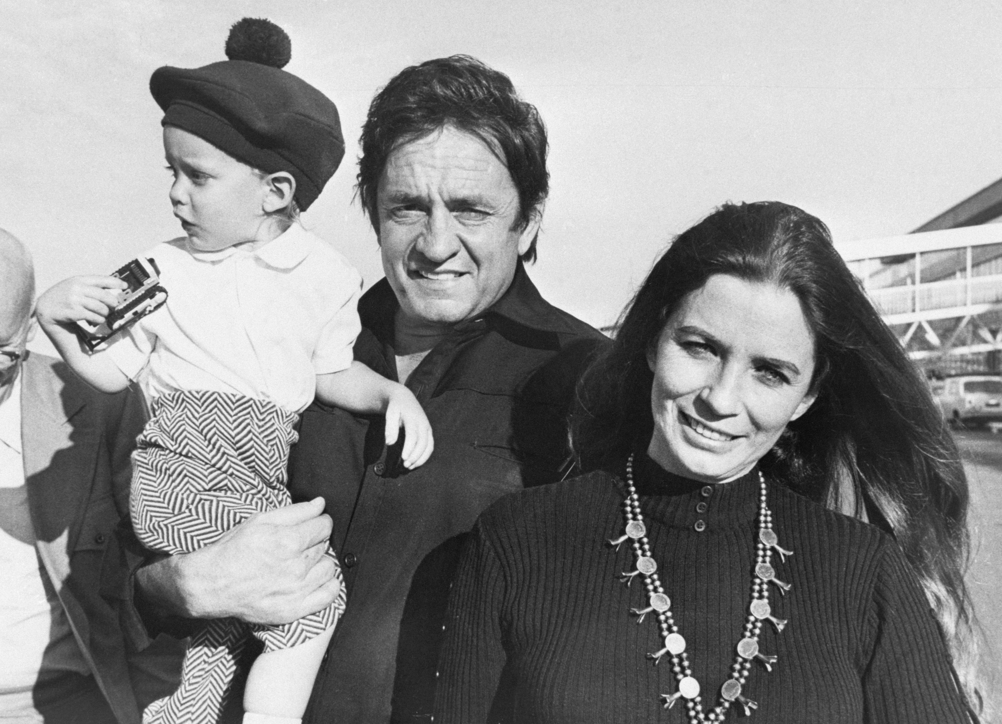 Johnny Cash with June Carter and their son John arrive for the filming of "Following the Footsteps of Jesus," on November 9, 1971 | Source: Getty Images