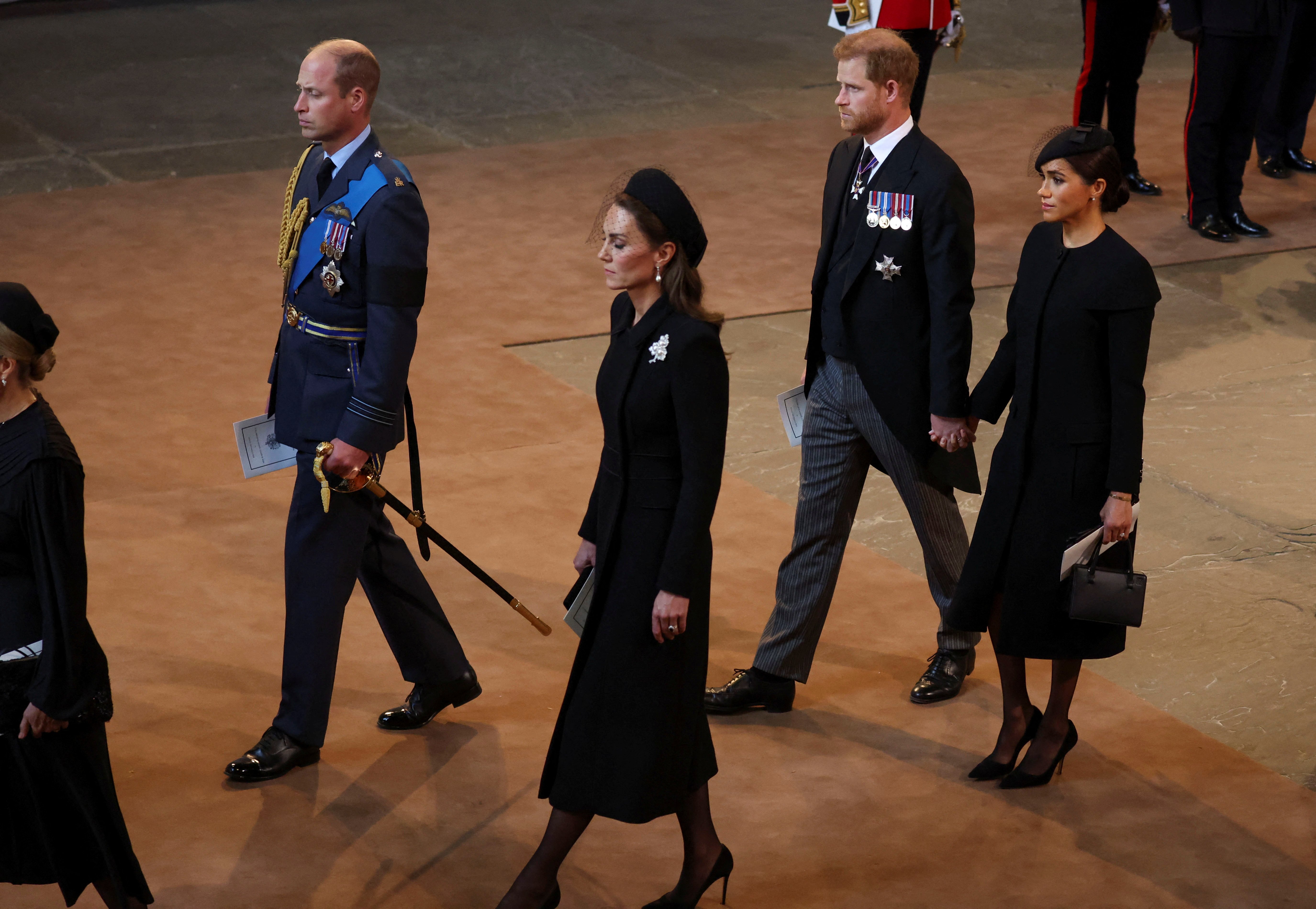 Prince William, Kate Middleton, Prince Harry and Meghan Markle walk as procession with the coffin of Queen Elizabeth II arrives at Westminster Hall for her lying in state, on September 14, 2022 in London, United Kingdom | Source: Getty Images