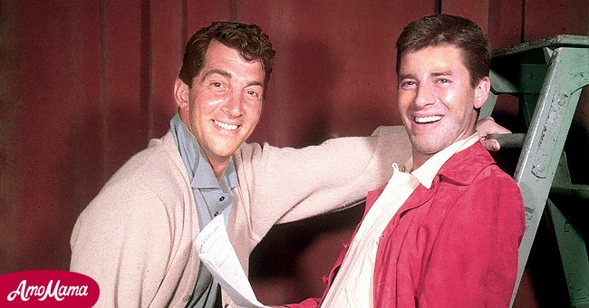 Dean Martin (1917-1995), US actor and singer, with Jerry Lewis, US actor and comedian, smiling in a studio portrait, with Lewis holding a script while leaning against a step ladder, USA, circa 1952. | Source: Getty Images