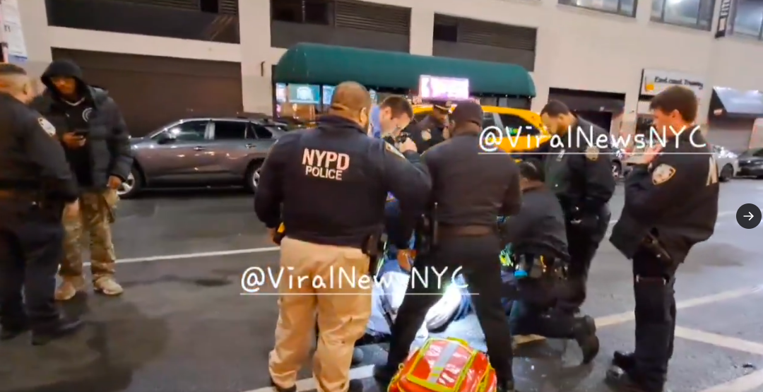 An influx of police officers and first responders gathered around Kris Boyd, who lays on the pavement, posted on November 16, 2025. | Source: X/@ViralNewsNYC