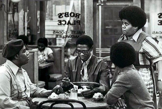 Shirley Hemphill looking at  Fred Berry, Ernest Lee Thomas, and Haywood Nelson while shooting "What's Happening!!" circa 1977 | Source: Wikimedia Commons
