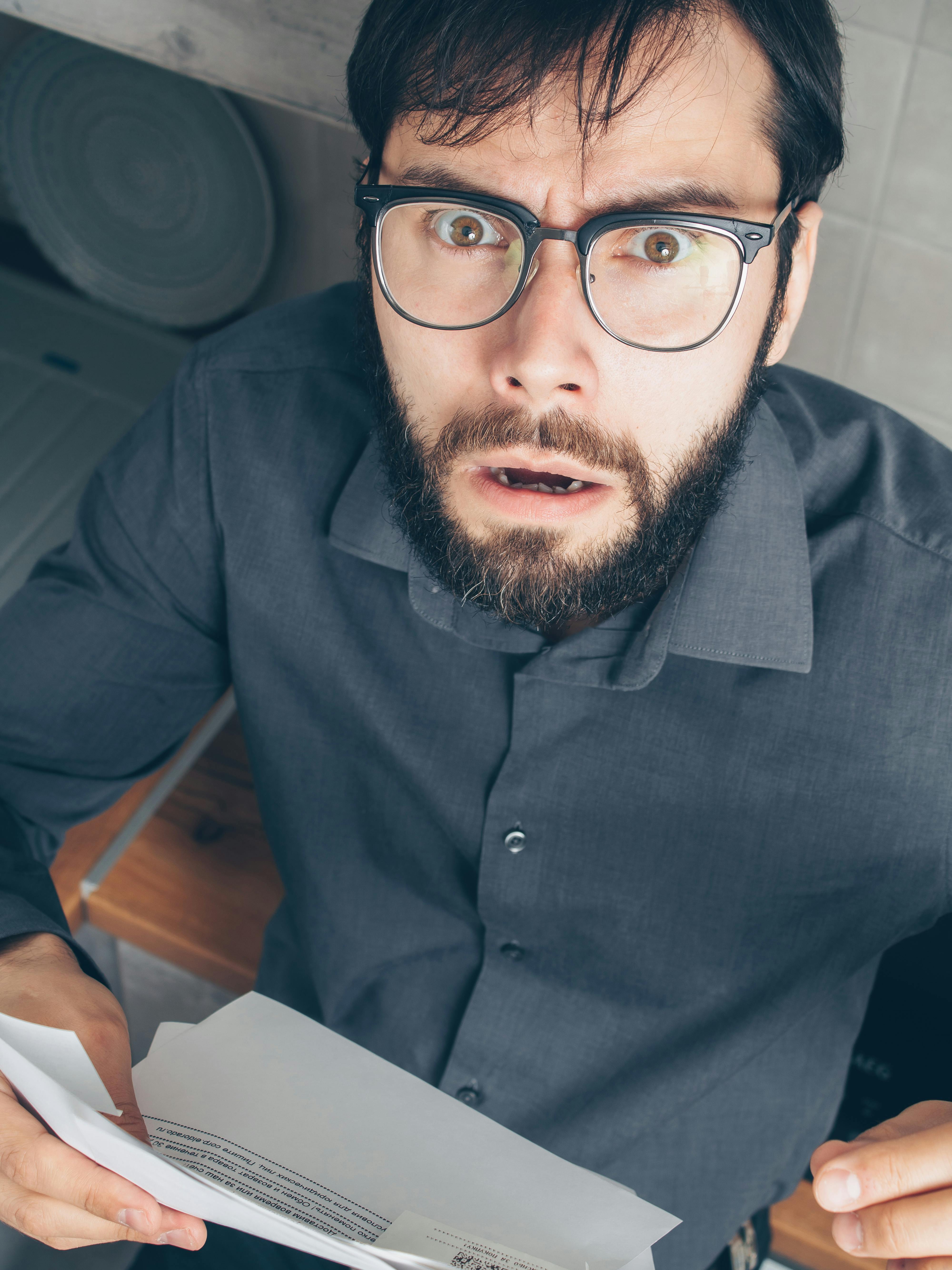 A surprised man looking up at the camera | Source: Pexels