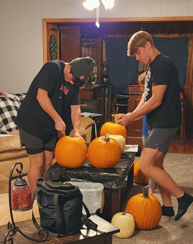 Ayden Beeson and a classmate carving pumpkins in a picture uploaded on June 28, 2024 | Source: Facebook/Ashley Edwards