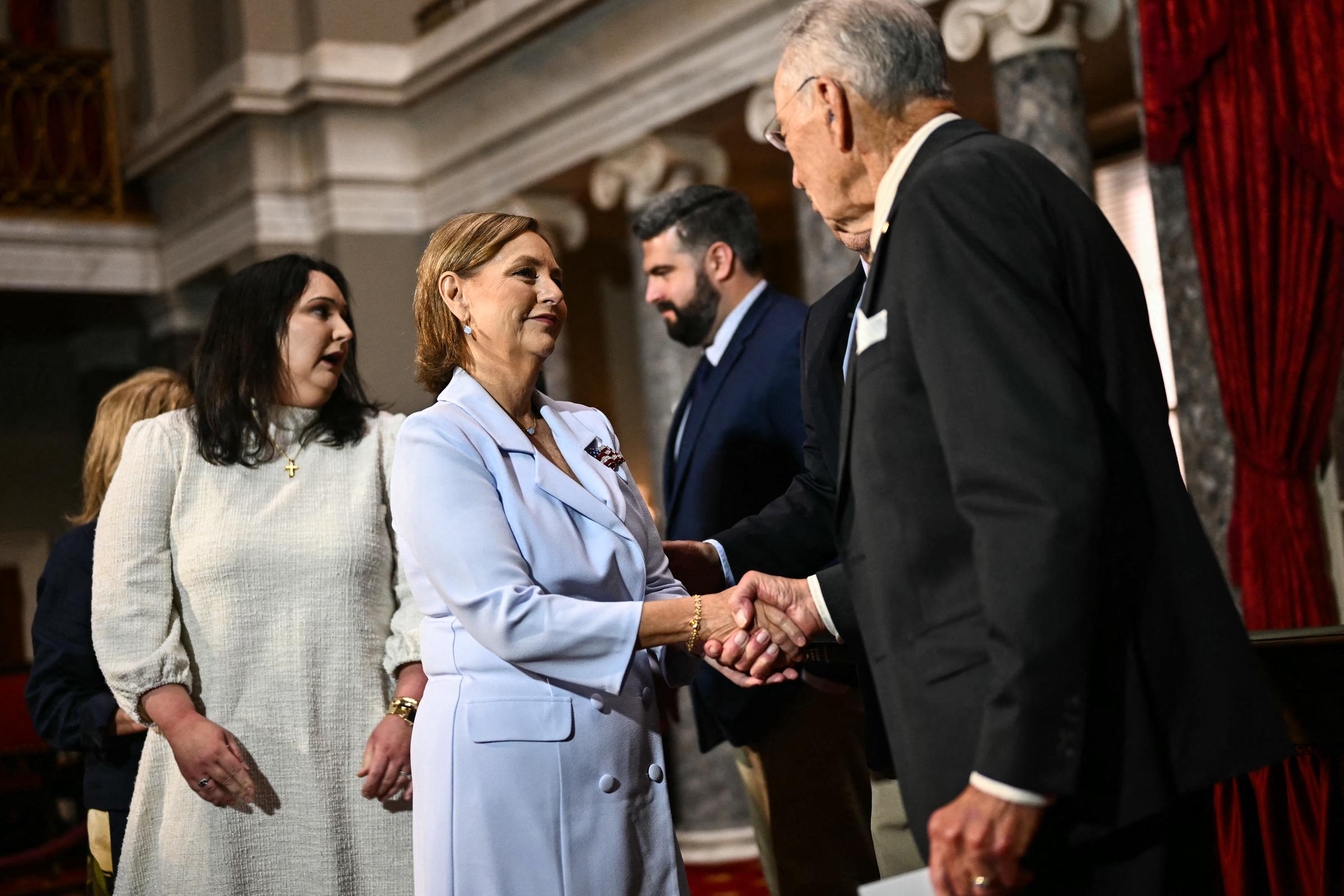 Following her ceremonial swearing-in on July 14, 2026, newly appointed Senator Darline Graham Nordone shares a warm handshake with Iowa Senator Chuck Grassley in the historic Old Senate Chamber. | Source: Getty Images