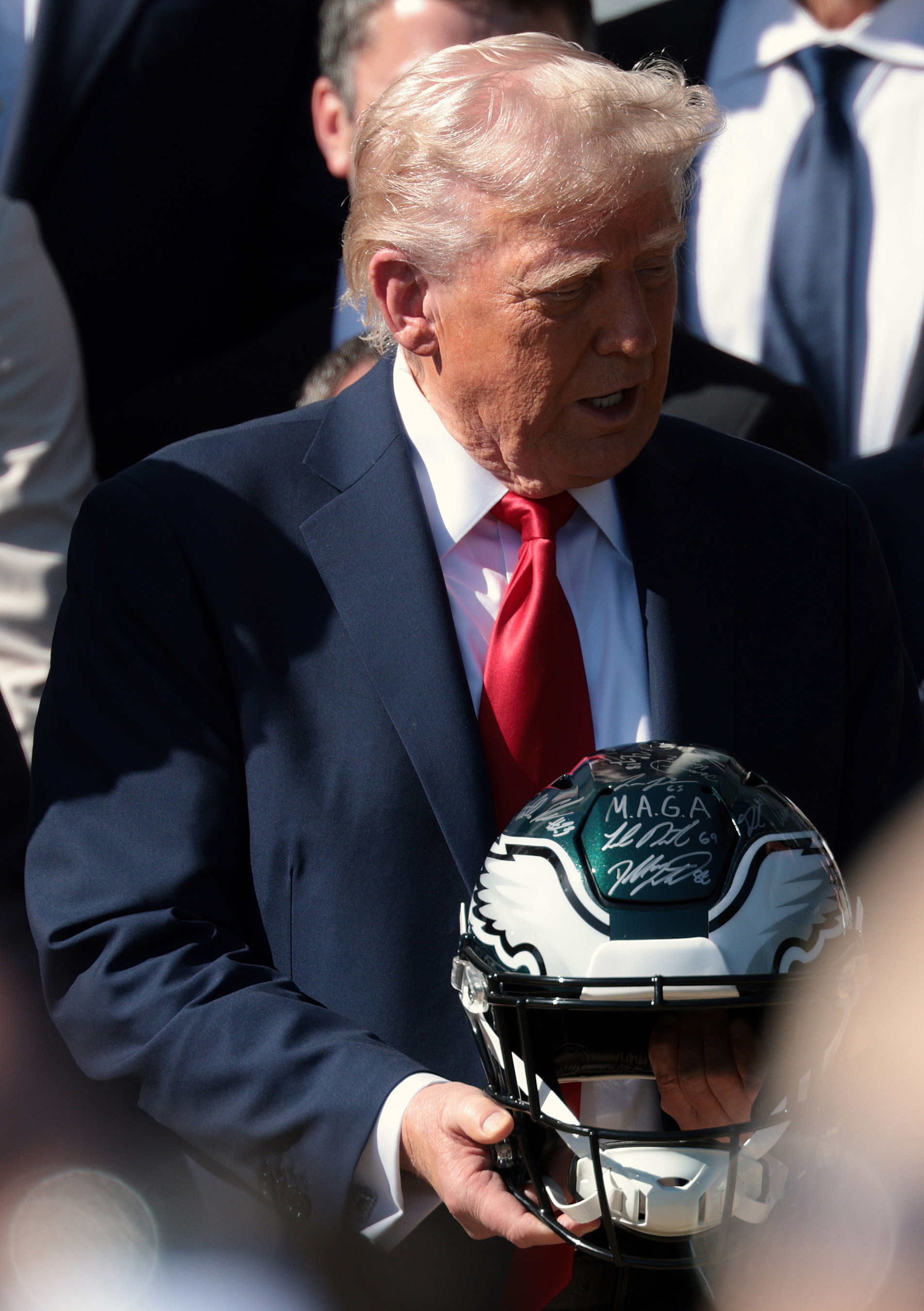 Donald Trump holds a helmet at an event welcoming the Super Bowl Champion Philadelphia Eagles on the South Lawn of the White House on April 28, 2025, in Washington, D.C. | Source: Getty Images