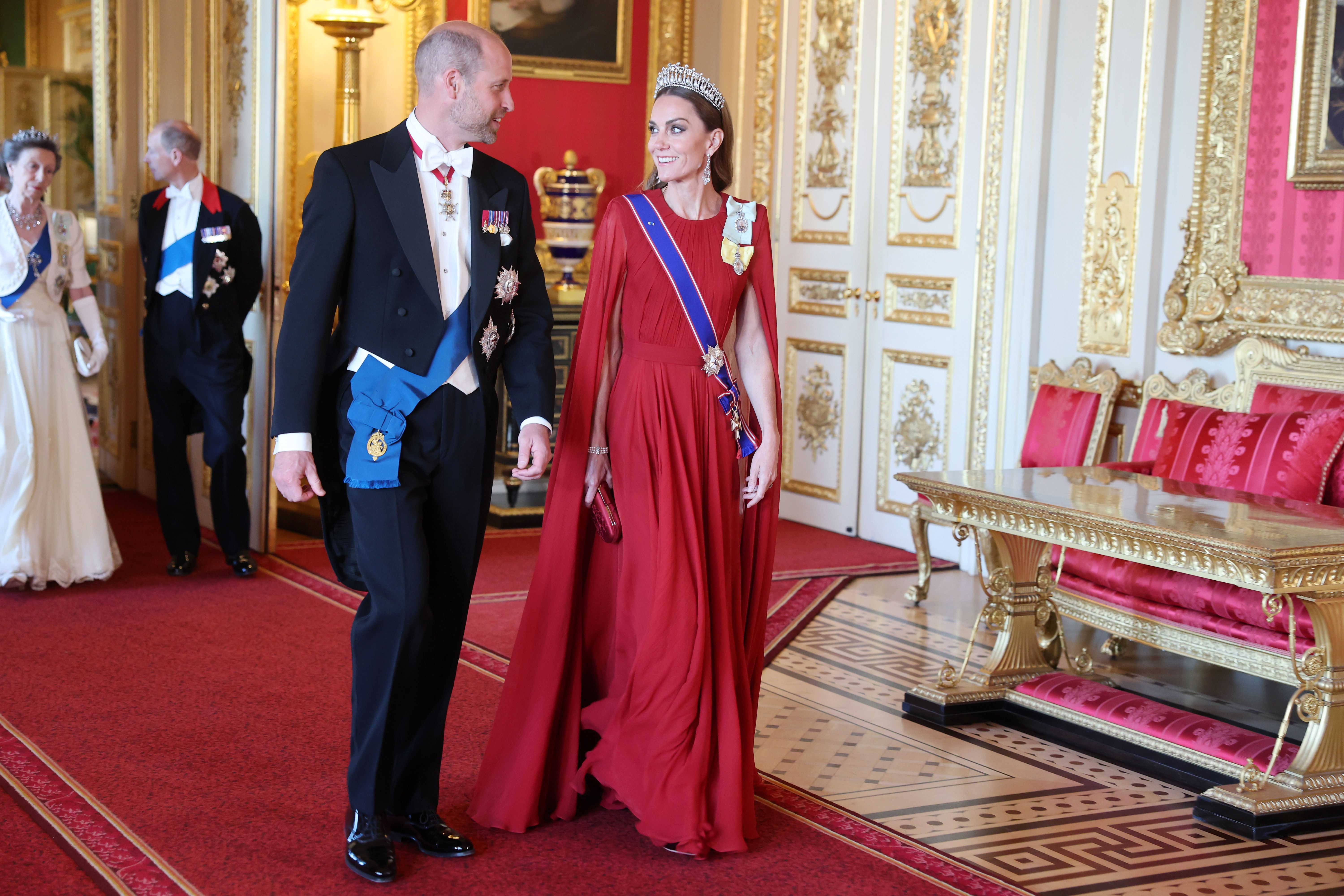 Prince William and Princess Catherine share a glance as they make a red carpet entrance to the state banquet hosted by the British royal family for French President Emmanuel Macron and First Lady Brigitte Macron during their official state visit to the United Kingdom.