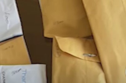 Envelopes of cash that Vicky Umodu found. | YouTube / 6abc Philadelphia 
