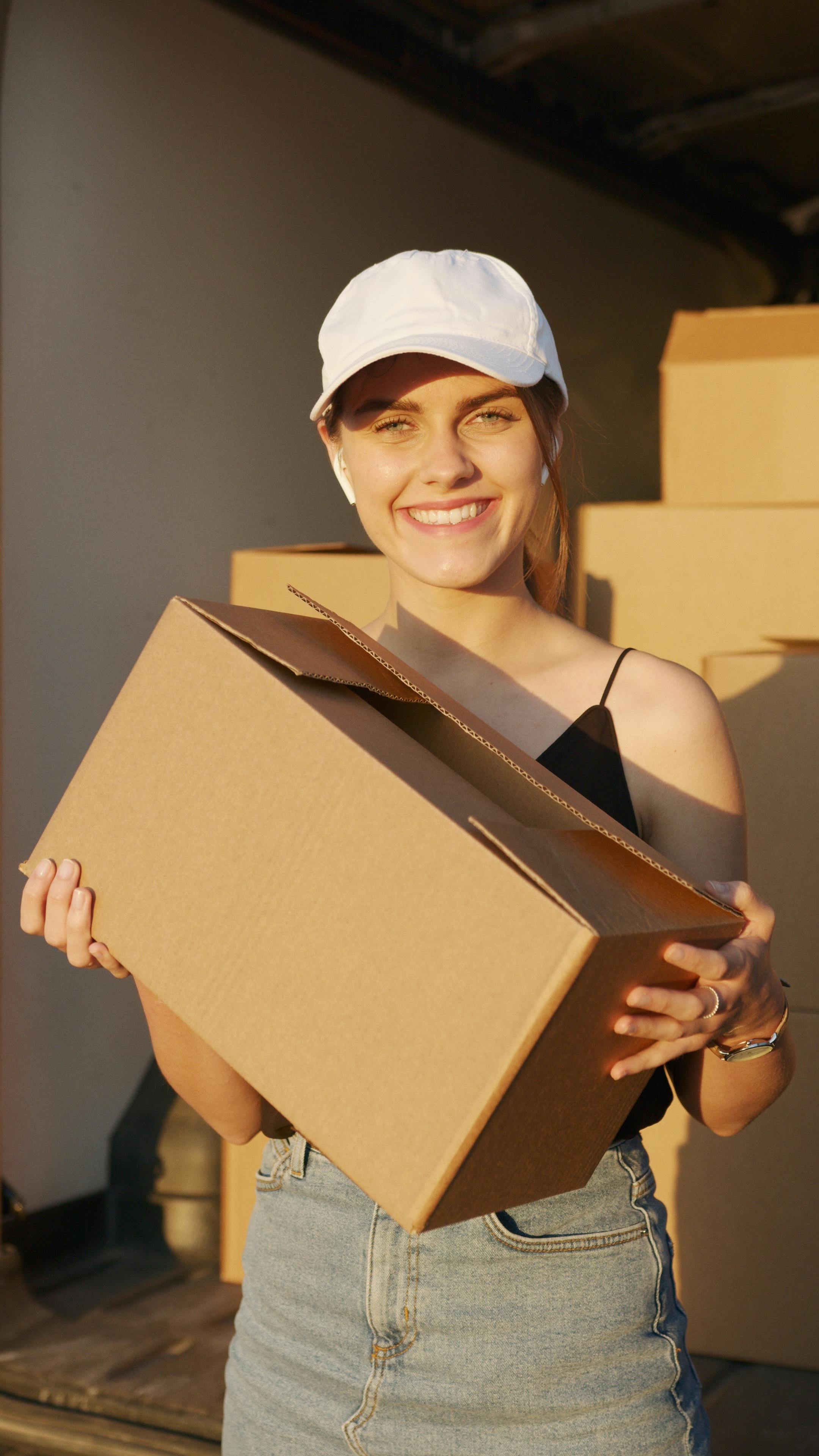 A woman holding a box | Source: Pexels