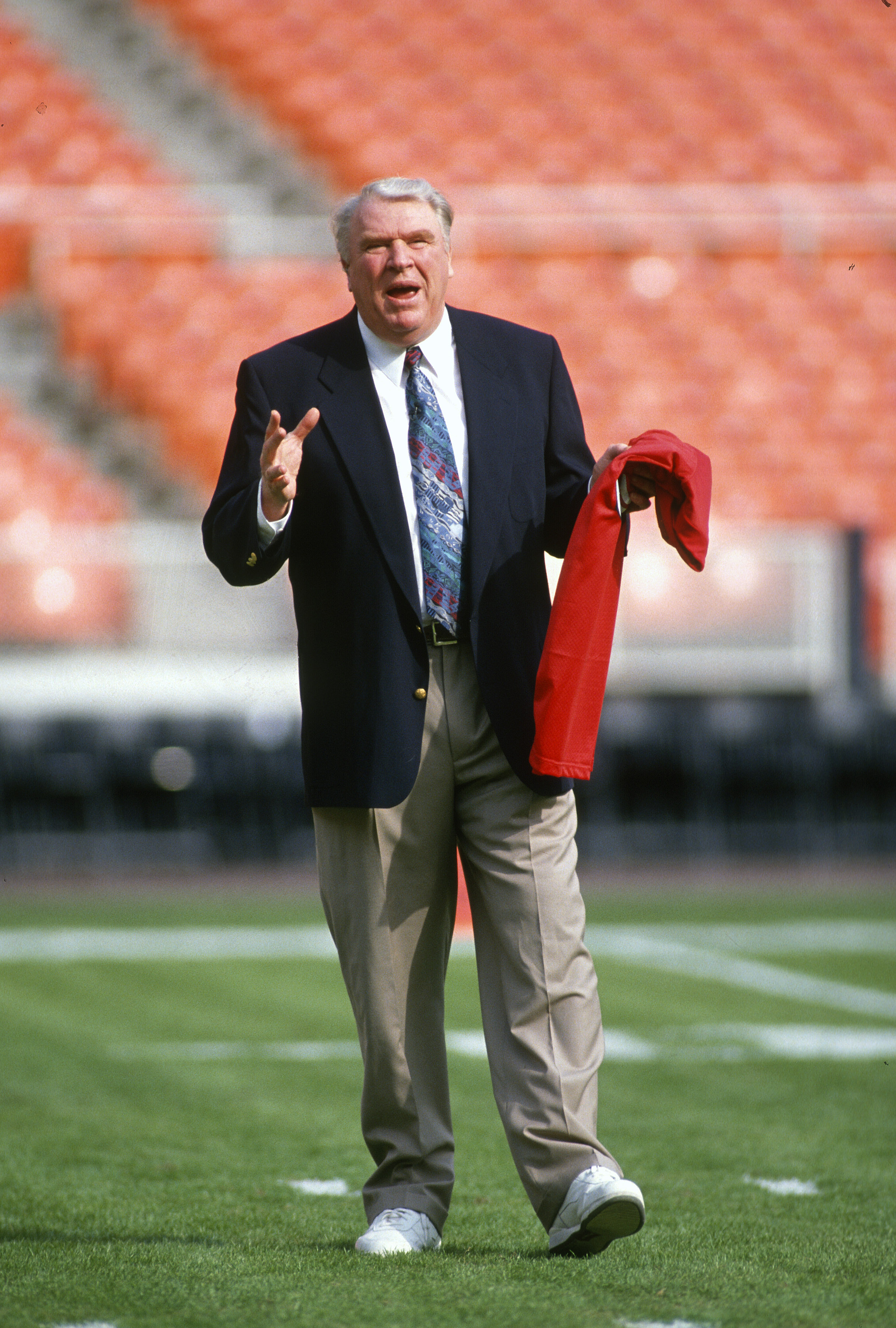 John Madden walks on the field prior to the start of an NFL Football game in 1994. | Source: Getty Images