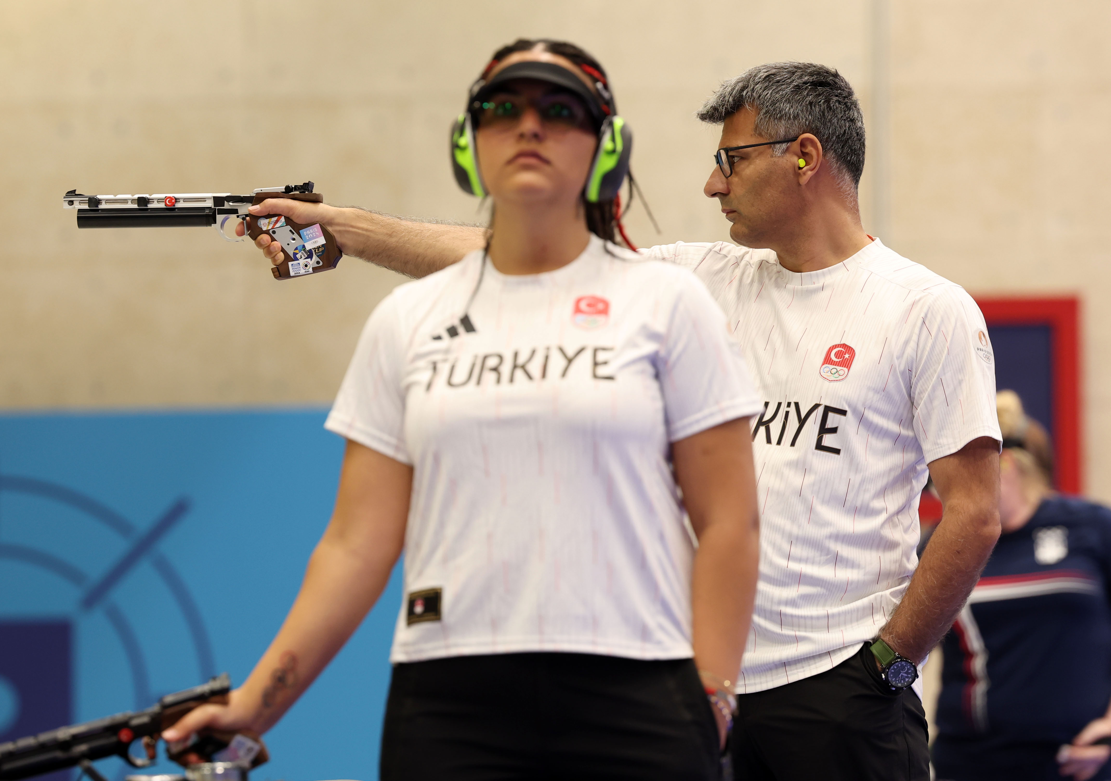 Sevval Ilayda Tarhan and the former officer compete in the shooting 10m air pistol mixed team match at the Paris Olympic Games on July 30, 2024, in Chateauroux, France | Source: Getty Images