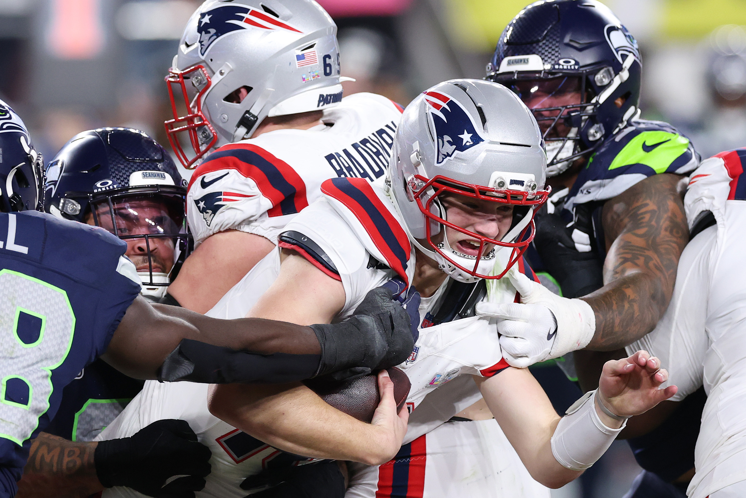 New England Patriots quarterback Drake Maye is sacked by Seattle Seahawks defenders Derick Hall, Byron Murphy II, and Leonard Williams during Super Bowl LX | Source: Getty Images