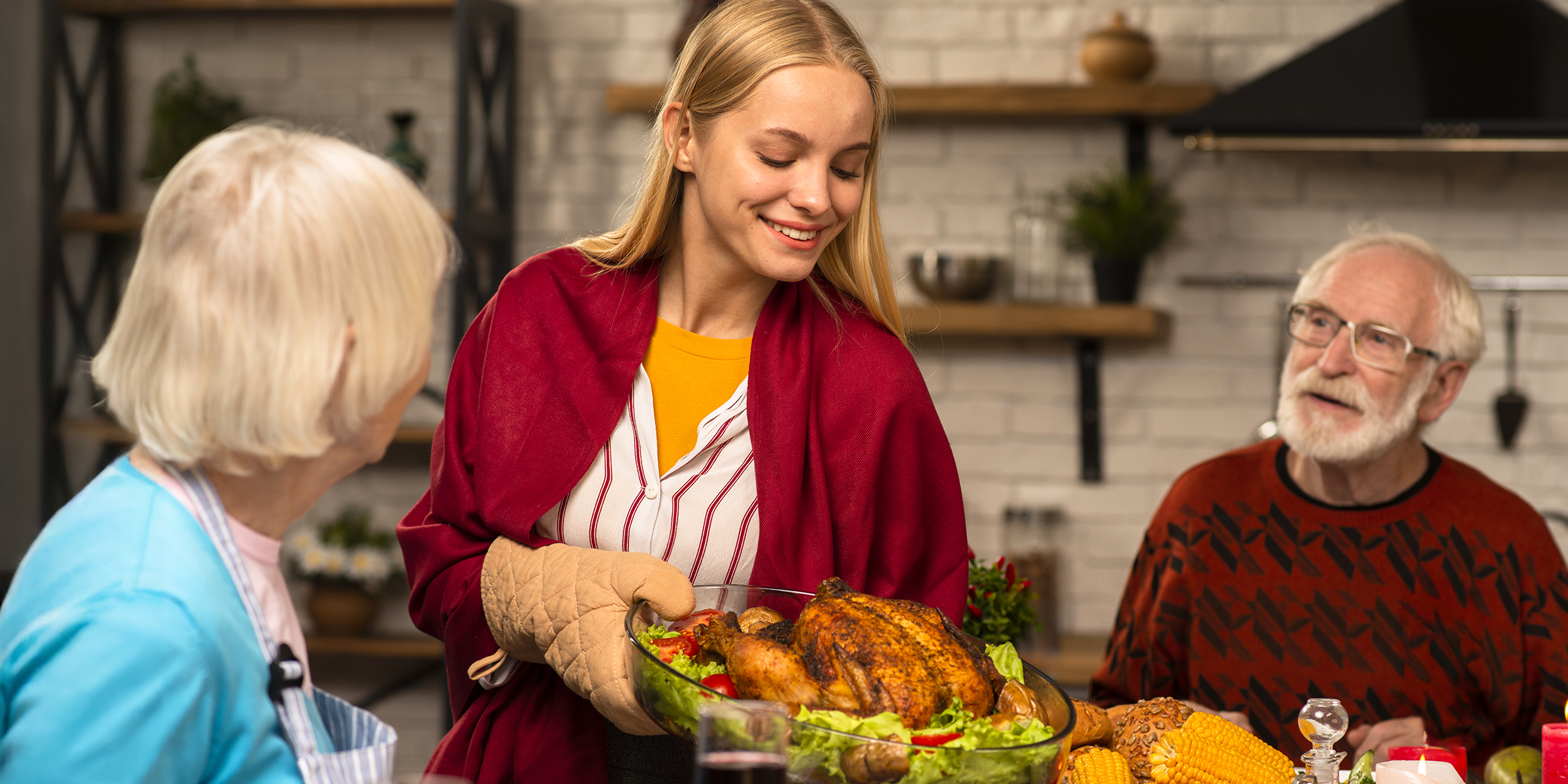 A woman serving an elderly couple for Thanksgiving | Source: Shutterstock