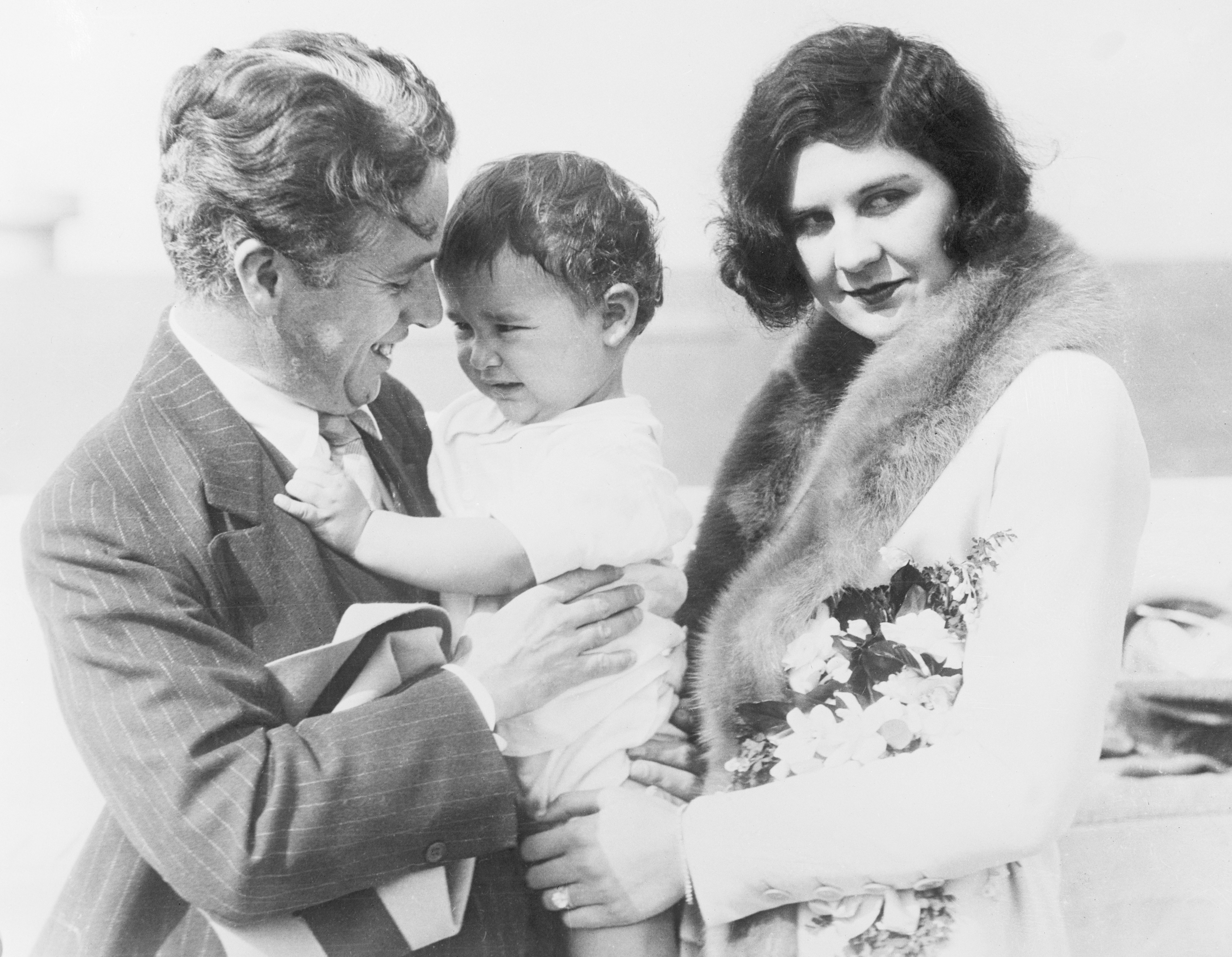 Charlie Chaplin, his second wife, Lita Grey, and their baby son, Charles Jr., photographed on board the SS City of Los Angeles in November 1926 | Source: Getty Images