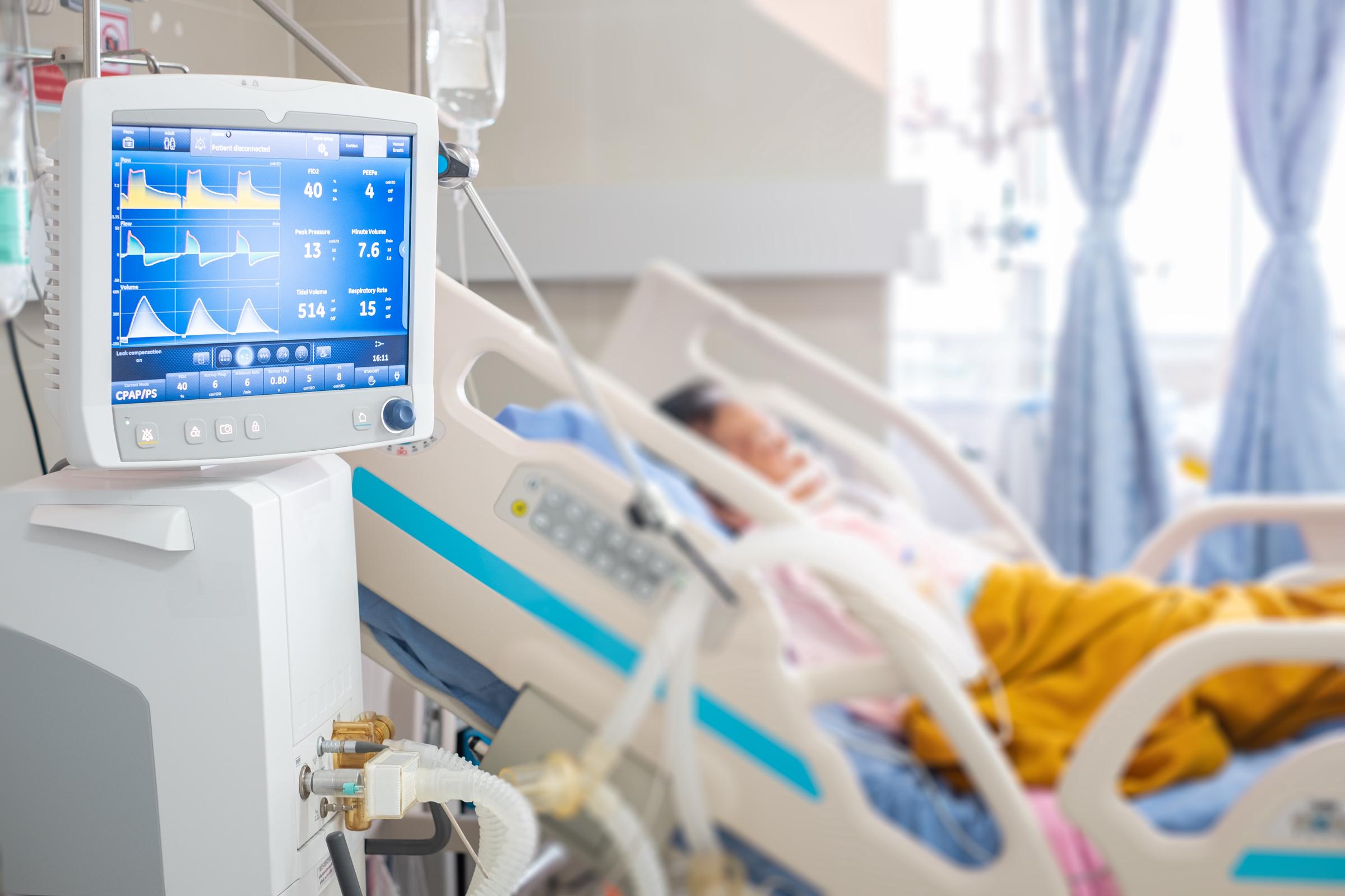 A ventilator monitor runs while a patient is given oxygen by an intubation tube in the emergency room | Source: Getty Images