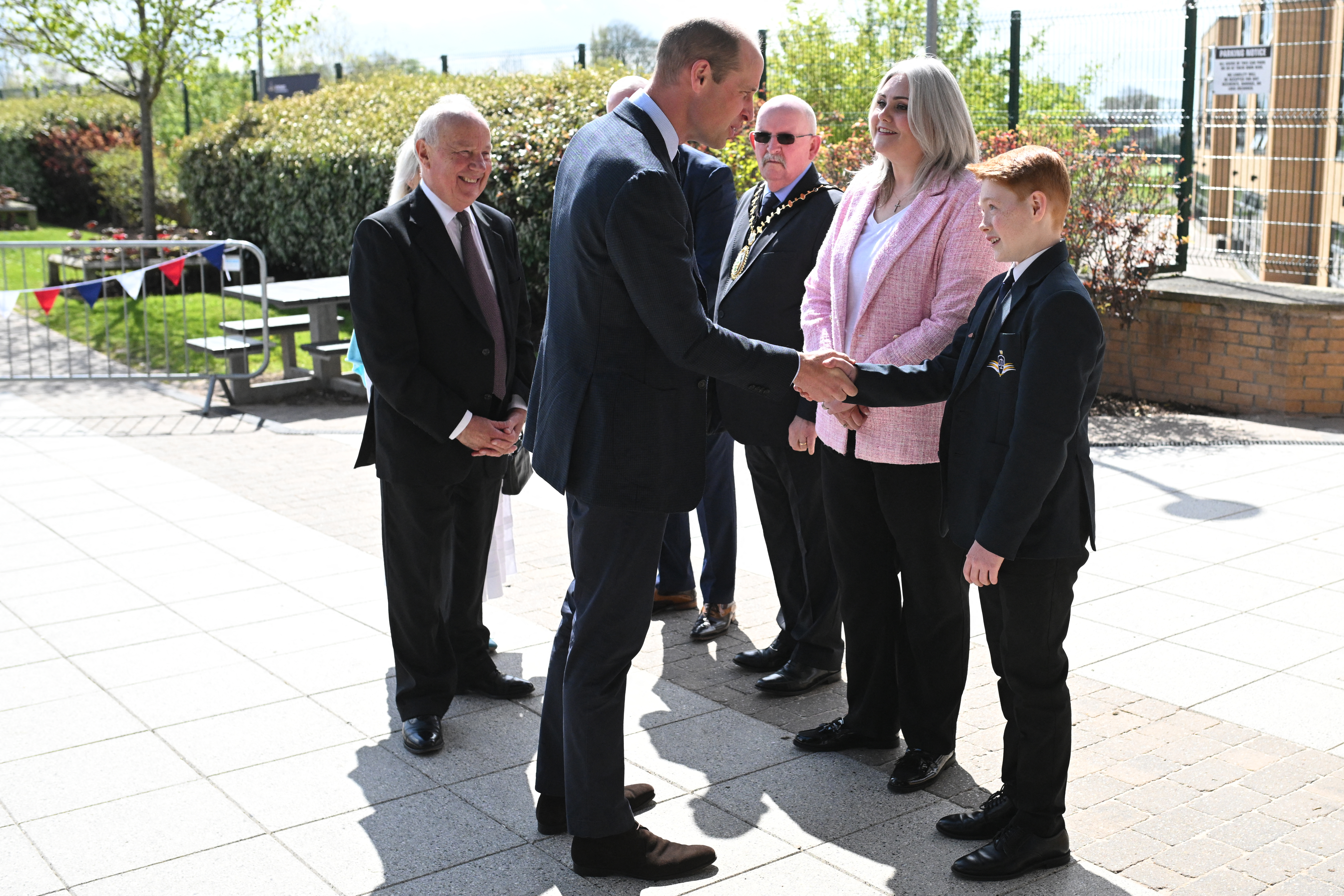 Prince William shakes hands with 12-year-old Freddie Hadley during a visit to St. Michael's Church of England High School in Rowley Regis, on April 25, 2024, in Birmingham, England. | Source: Getty Images