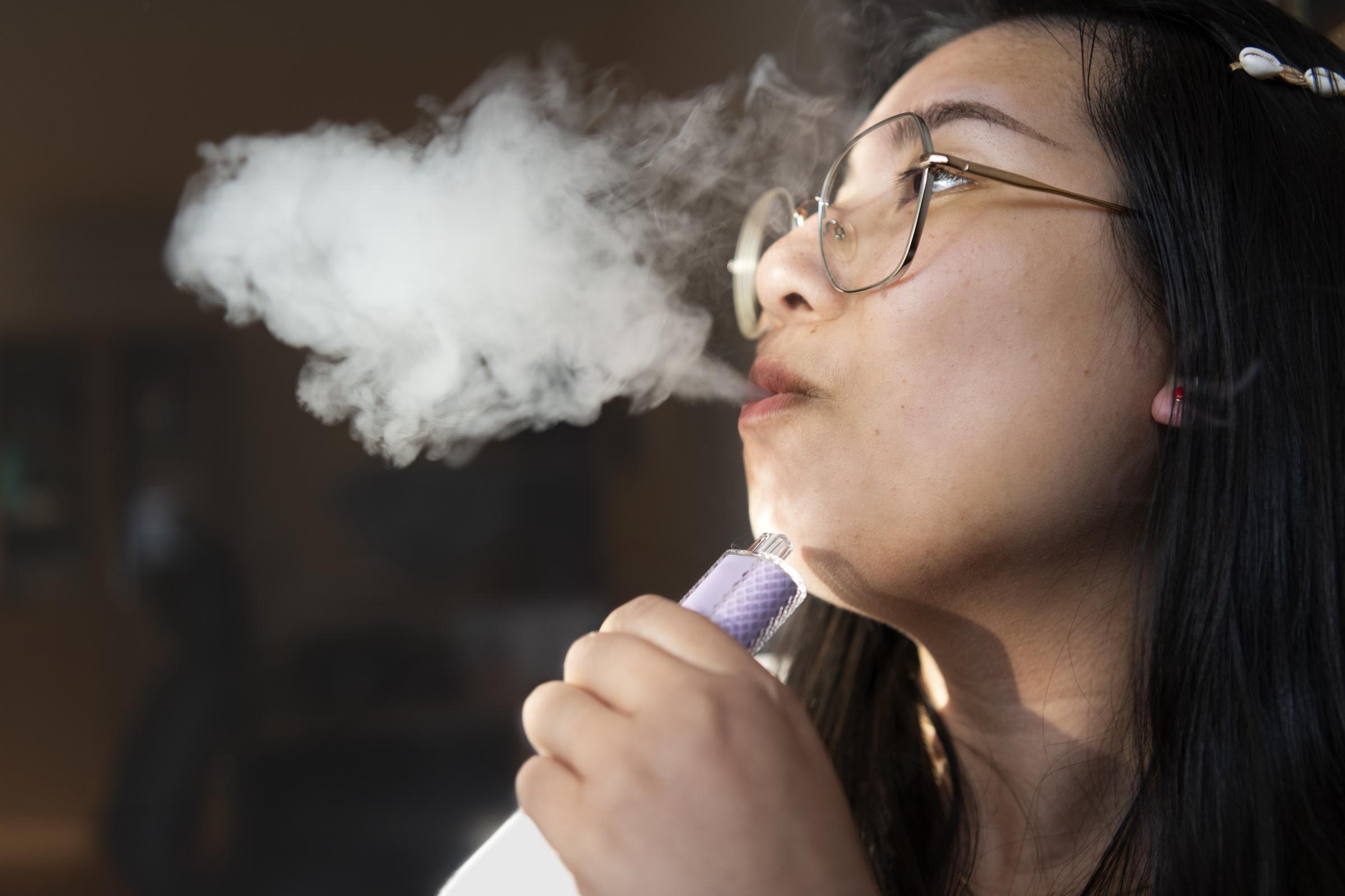 A woman vaping | Source: Getty Images