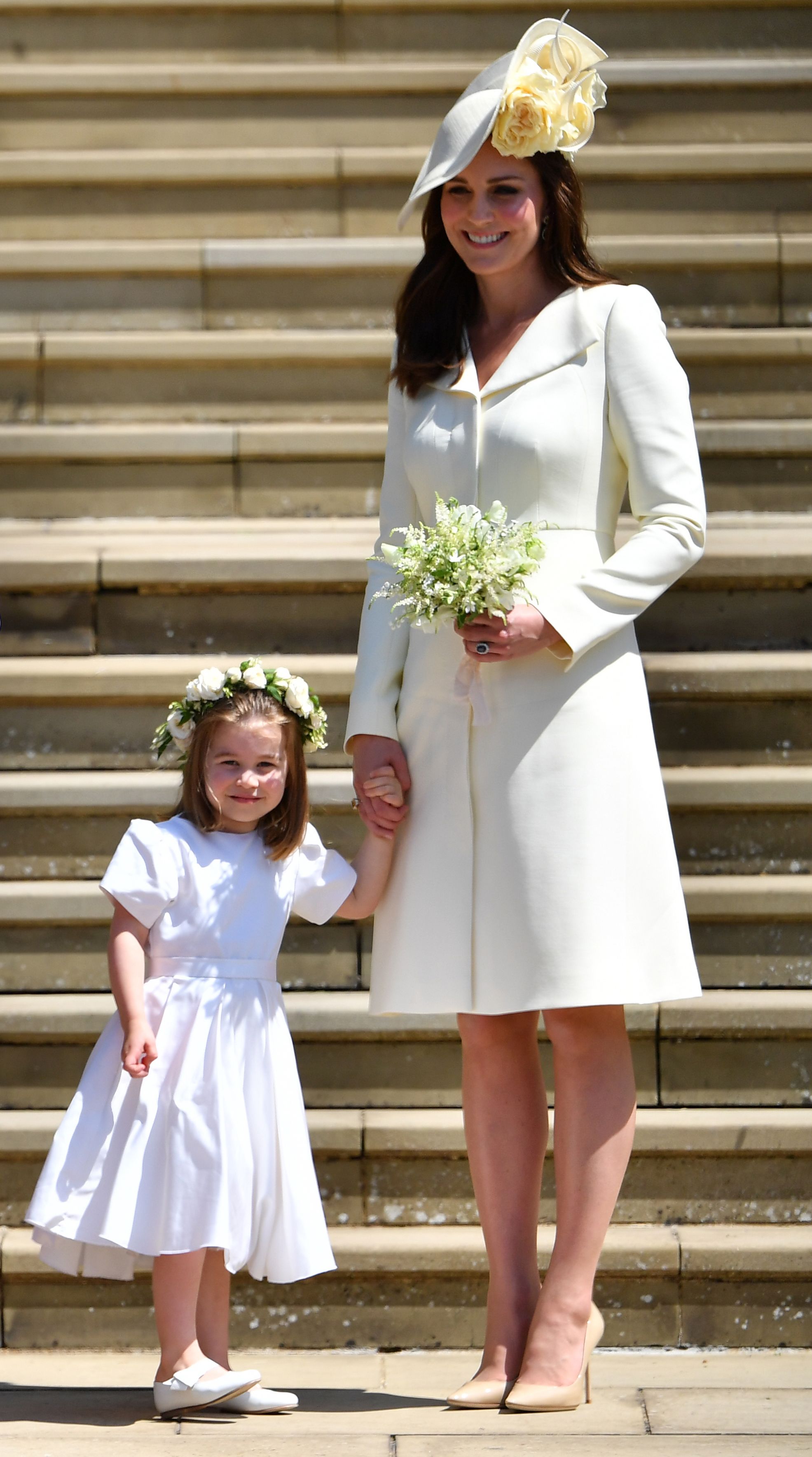 Princess Charlotte and Britain's Catherine, Duchess of Cambridge leave the wedding ceremony of Britain's Prince Harry, Duke of Sussex and US actress Meghan Markle at St George's Chapel, Windsor Castle, in Windsor, on May 19, 2018 | Source: Getty Images 