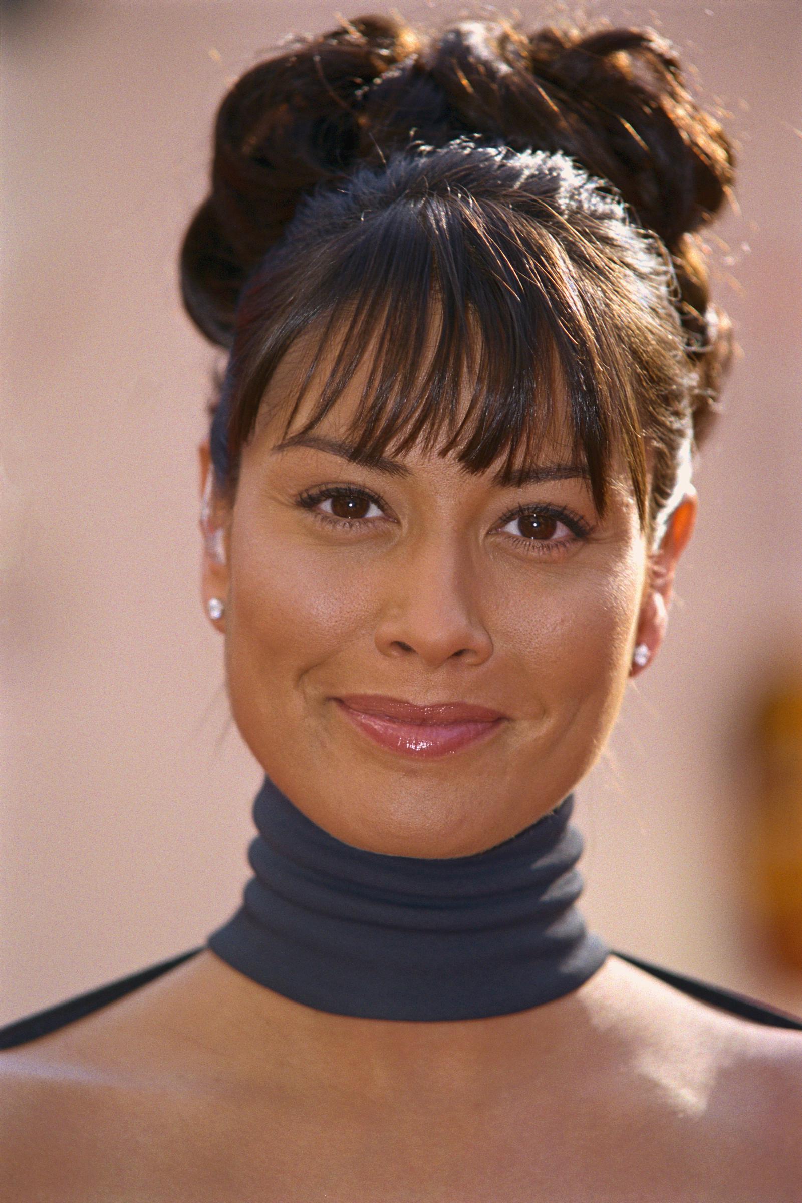 Melanie Sykes stuns at the BAFTA Awards in April 2000, radiating futuristic glamour with a sleek updo and soft fringe. With minimalist makeup and a bold high-neckline, the TV star exudes polished confidence and timeless red-carpet poise.
