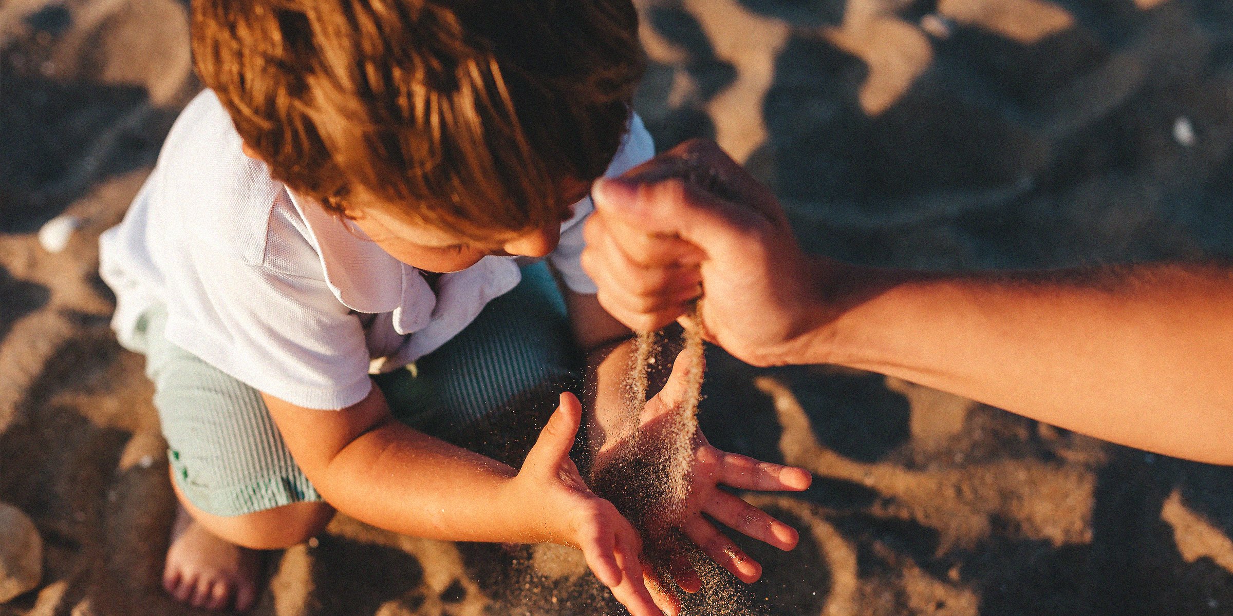 Unsplash.com | A child playing with sand 