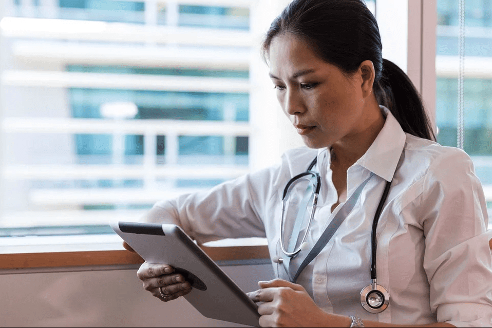A portait of a doctor going through her tab | Photo: Pixabay