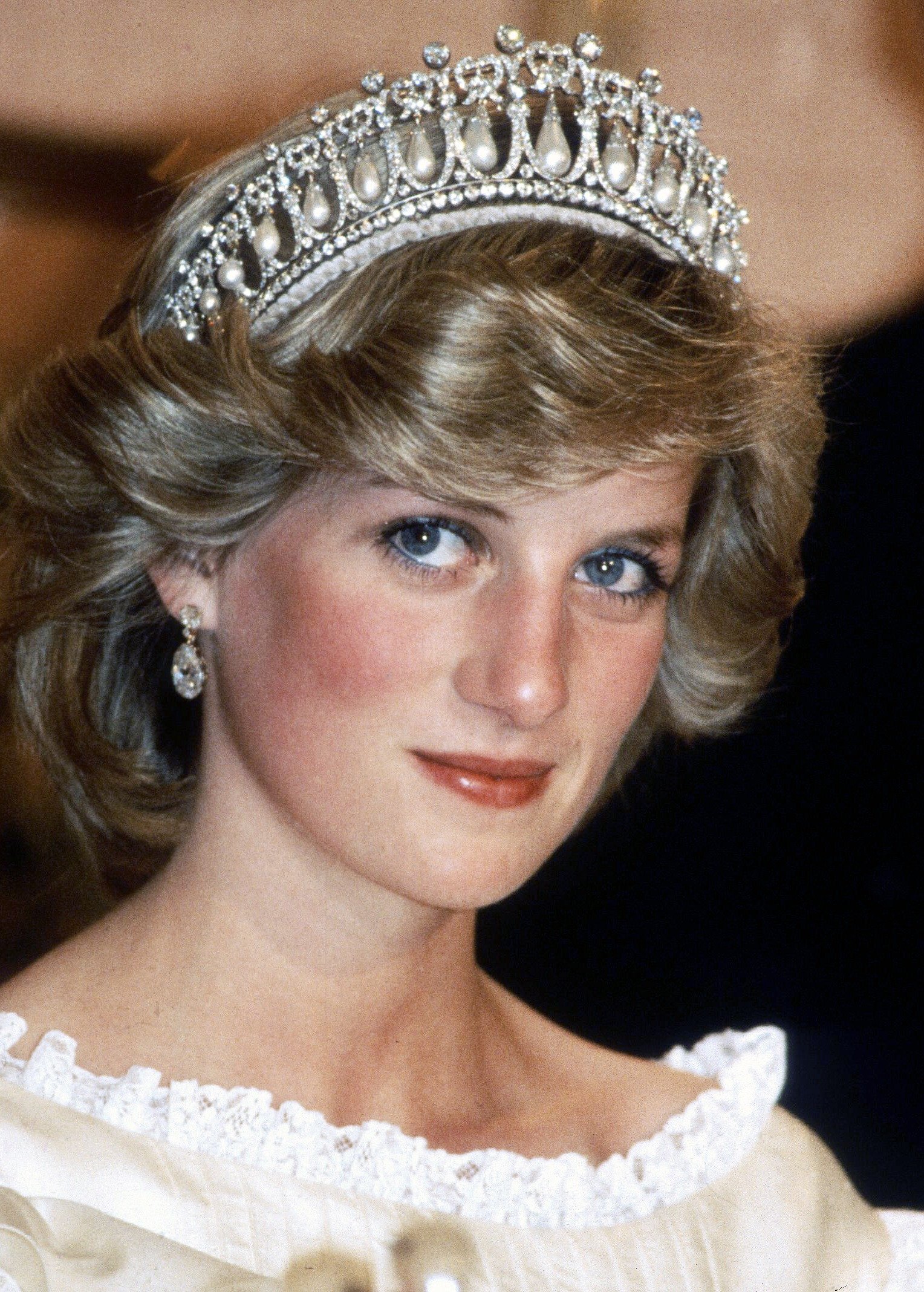 Diana, Prinzessin von Wales, trägt ein cremefarbenes Satinkleid von Gina Fratini mit der Queen Mary Cambridge Lover's Knot Tiara und Diamantohrringen bei einem Bankett am 29. April 1983 in Auckland, Neuseeland. | Quelle: Getty Images