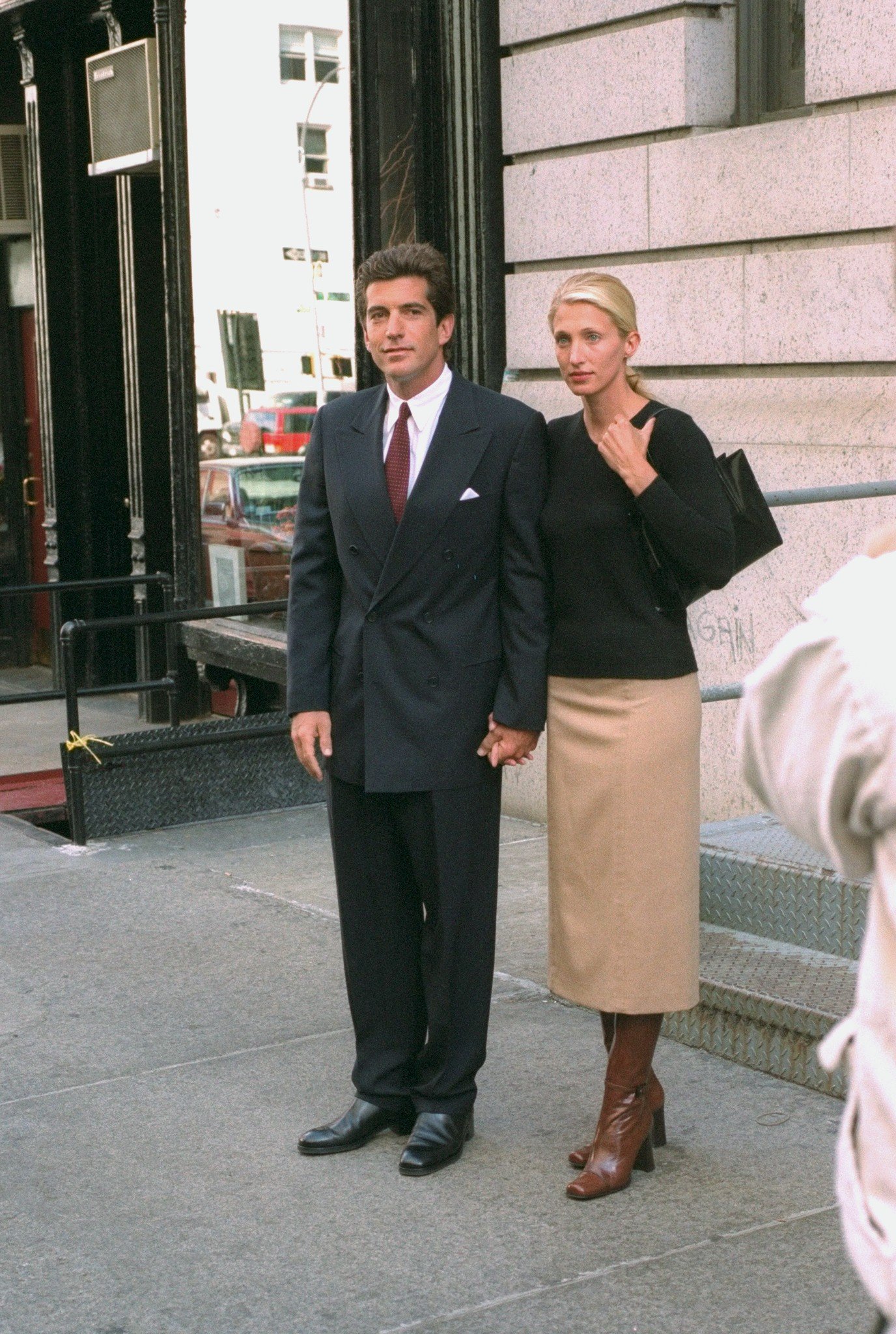 Newlyweds John F. Kennedy Jr. and Carolyn Bessette Kennedy standing in front of their apartment in Tribecca. / Source: Getty Images