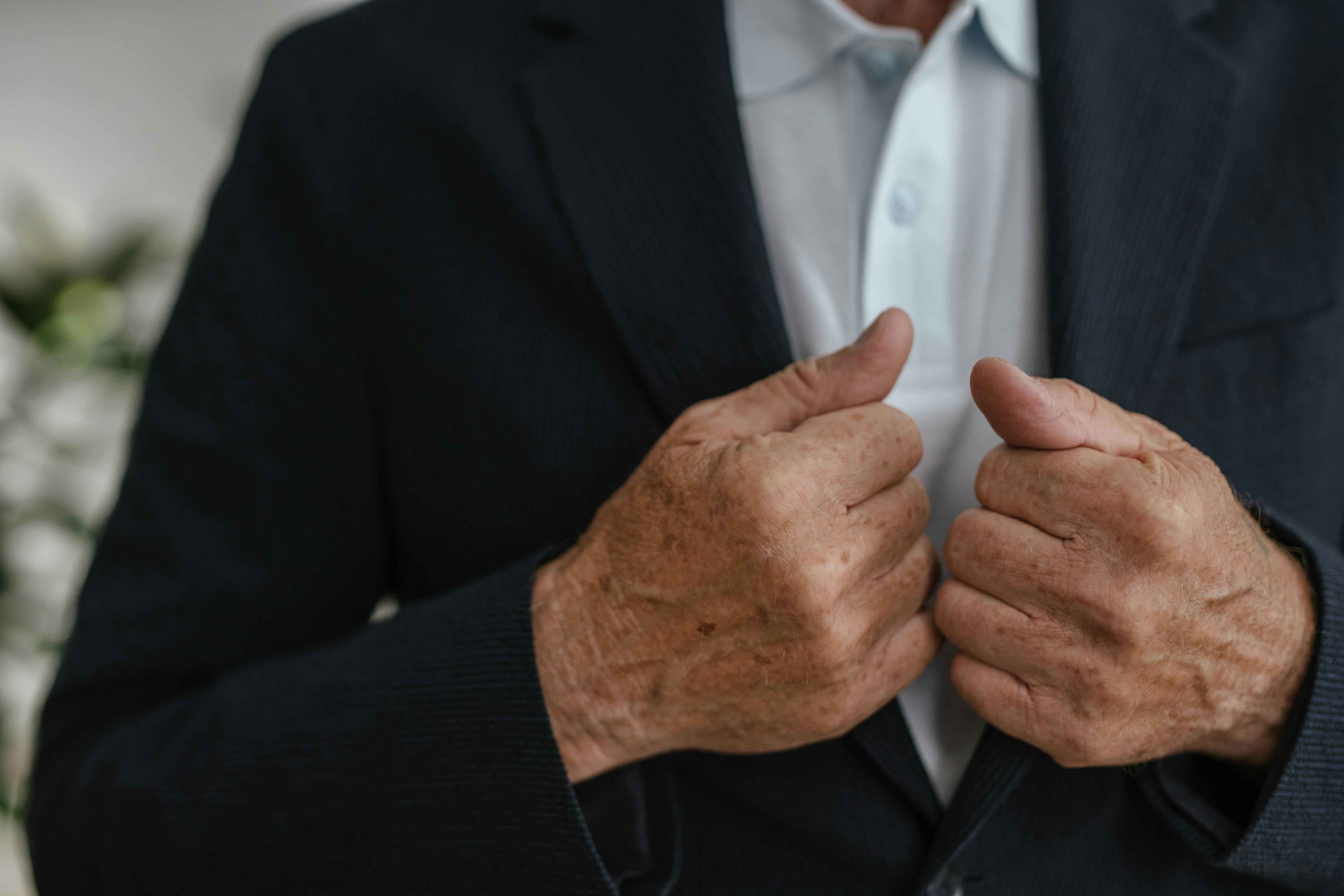 Close-up of a man holding his coat | Source: Pexels