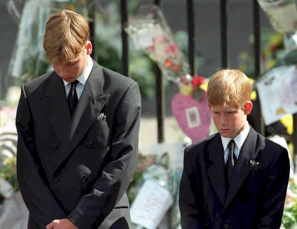 Prince William and Prince Harry pictured bowing their heads as their mother Princess Diana's coffin is taken out of Westminster Abbey following her funeral service September 6, 1997. / Source: Getty Images
