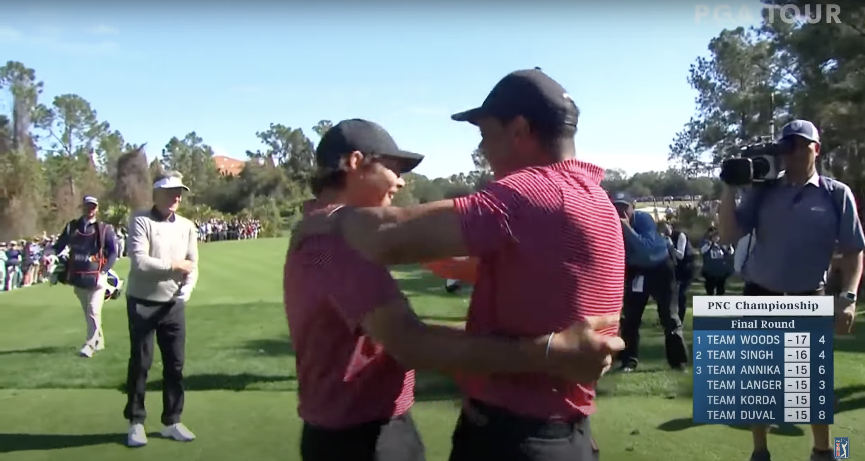 Charlie and Tiger Woods share a hug at the 2024 PNC Championship in Florida, posted on December 23, 2024 | Source: YouTube.com/PGATOUR