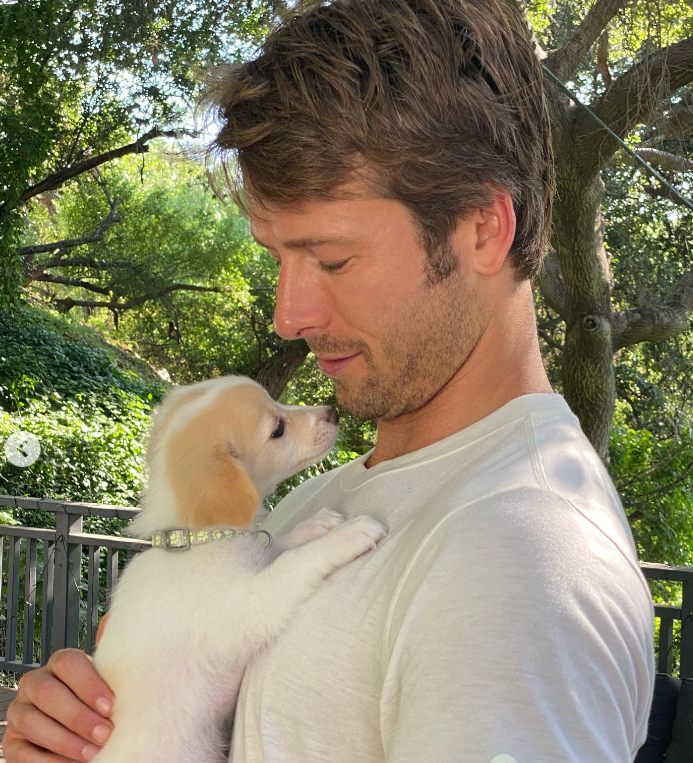 The actor holds his dog, dated July 5, 2023 | Source: Instagram/glenpowell