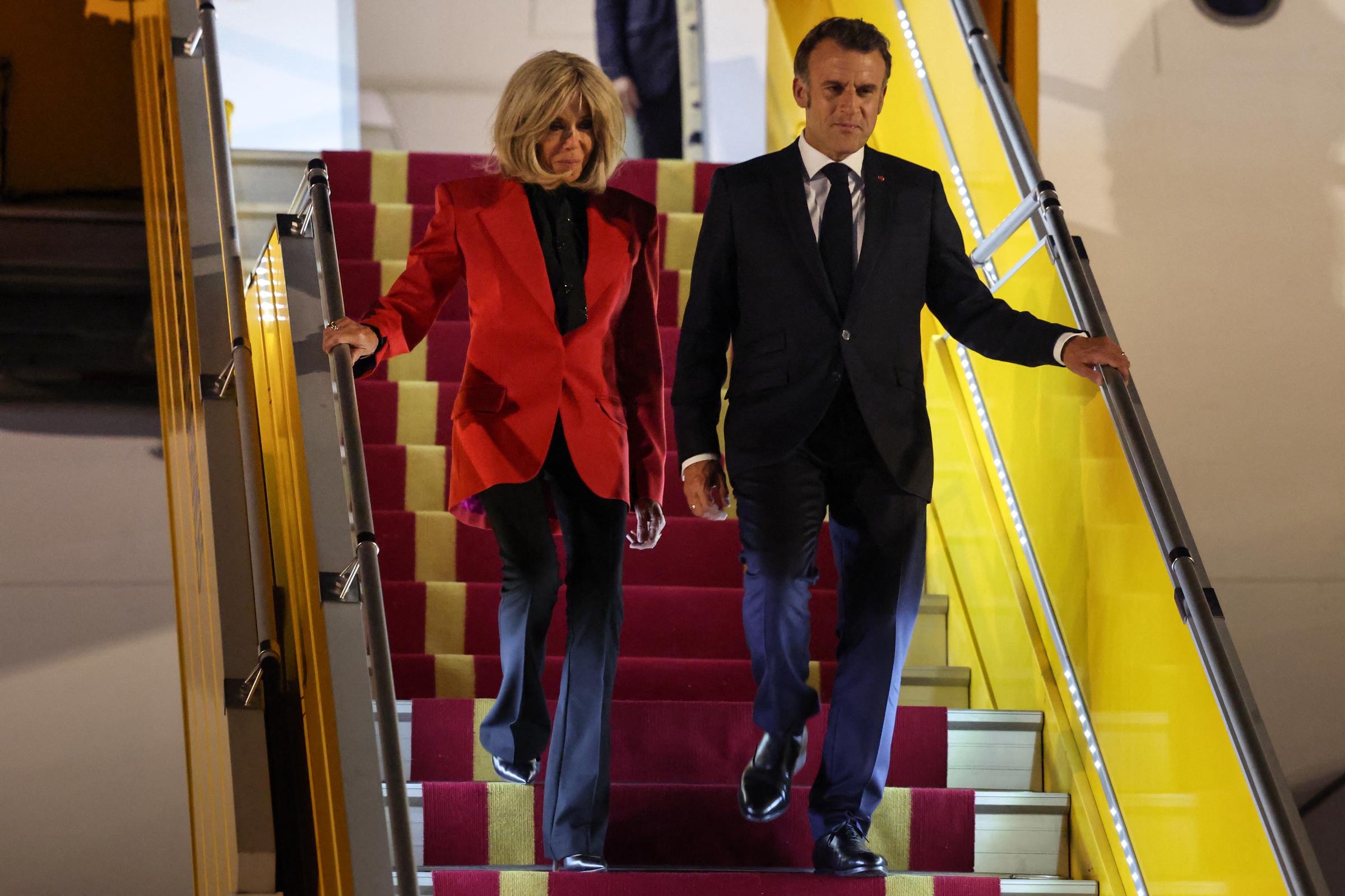 France's President Emmanuel Macron and his wife Brigitte disembark from the plane upon their arrival at Noi Bai International Airport in Hanoi on May 25, 2025 | Source: Getty Images