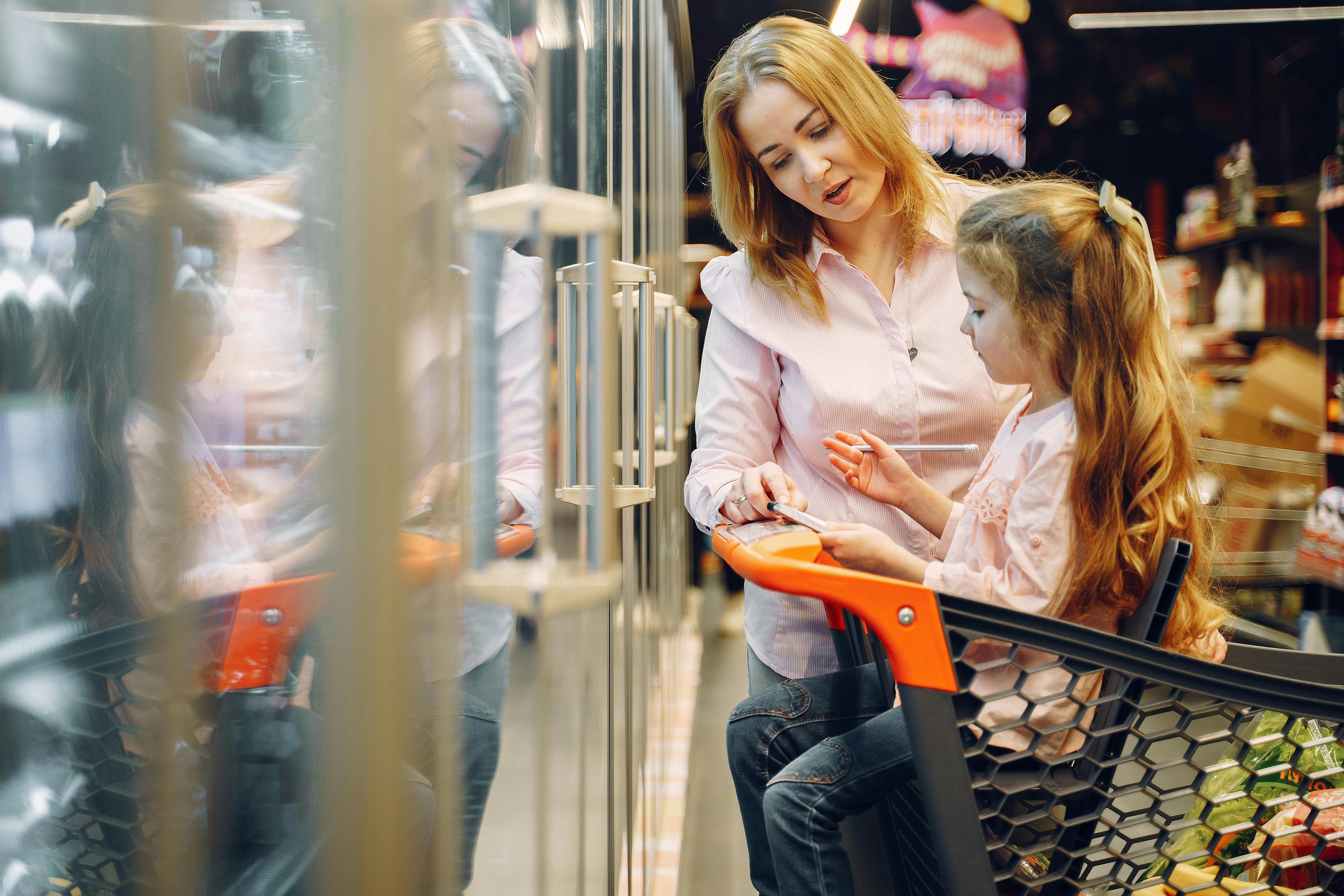 A woman with a child in a store | Source: Pexels