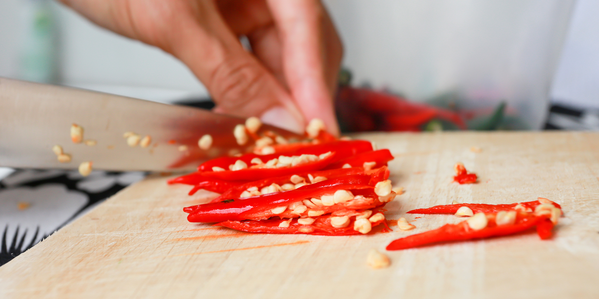 A person cutting a chili | Source: Shutterstock