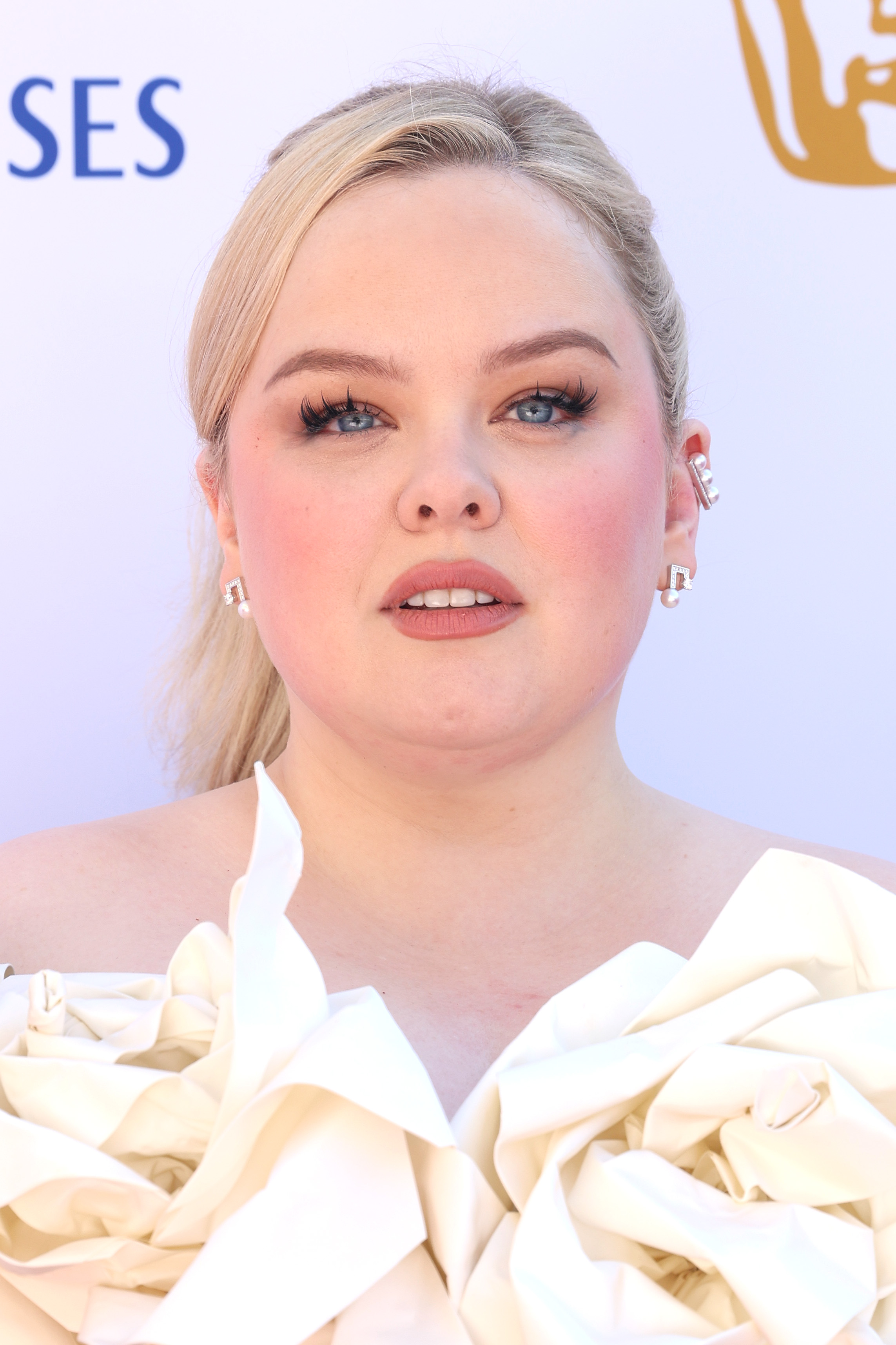 Coughlan, 38, lit up the 2025 BAFTA Television Awards in London with her porcelain skin, romantic makeup, and an off-the-shoulder gown adorned with dramatic sculptural florals. With soft blush tones and a sleek blonde ponytail, she channeled a fairy-tale elegance that felt delicate, dreamy, and unapologetically feminine.