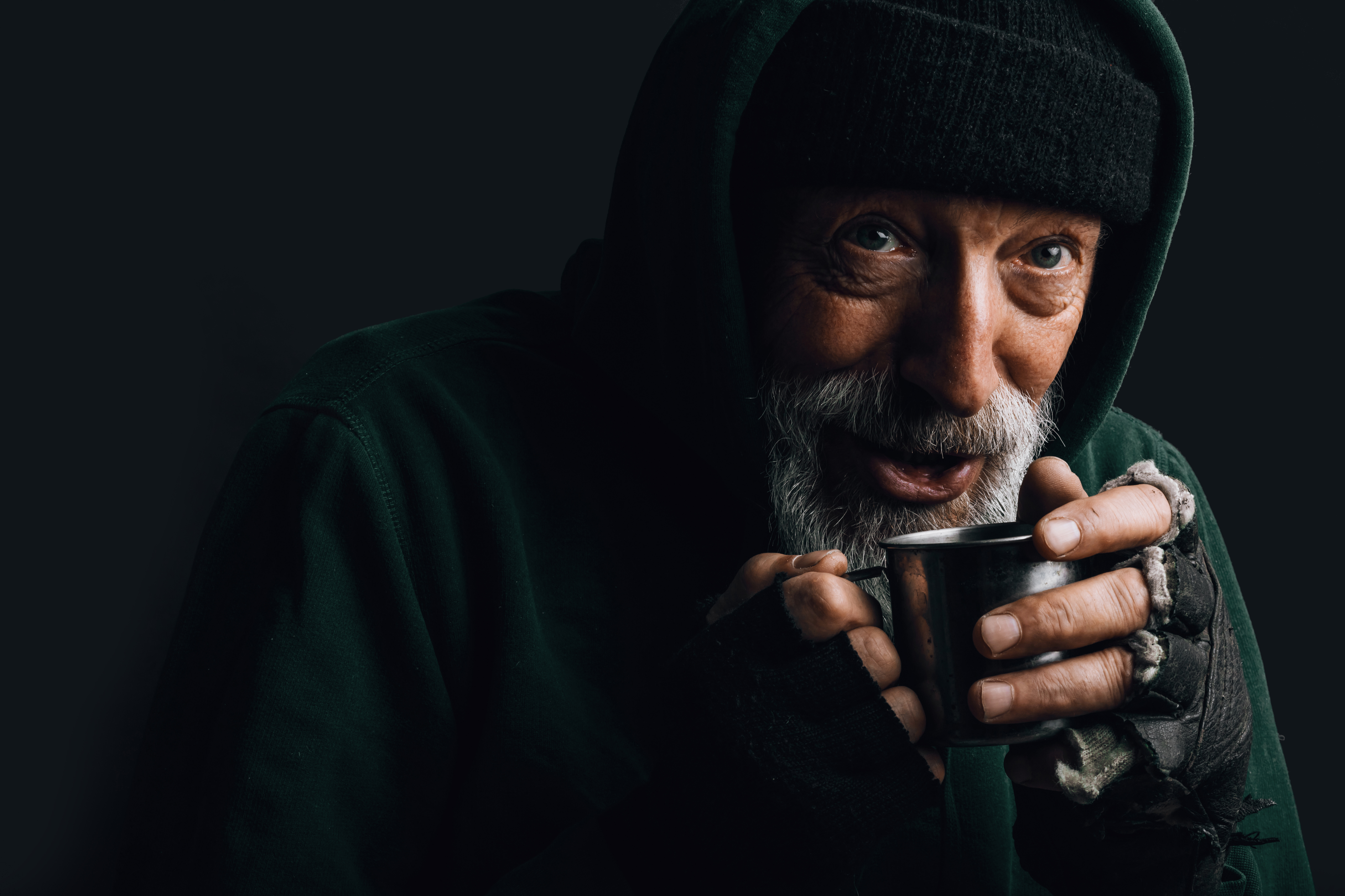 Homeless man drinking coffee | Source: Shutterstock