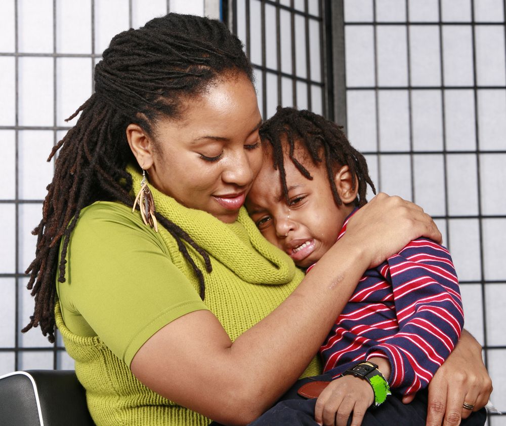 Little boy in tears in his mom's arms. | Photo: Getty Images