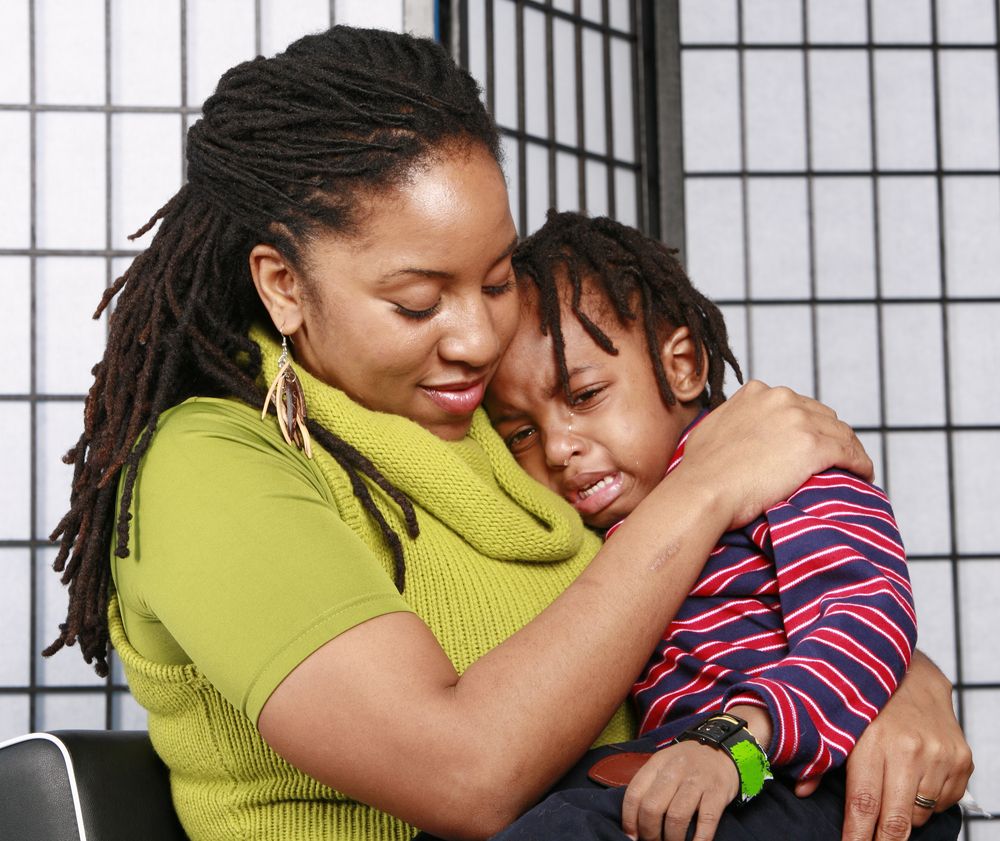 Little boy in tears having a cuddle from his mommy. | Source: Getty Images