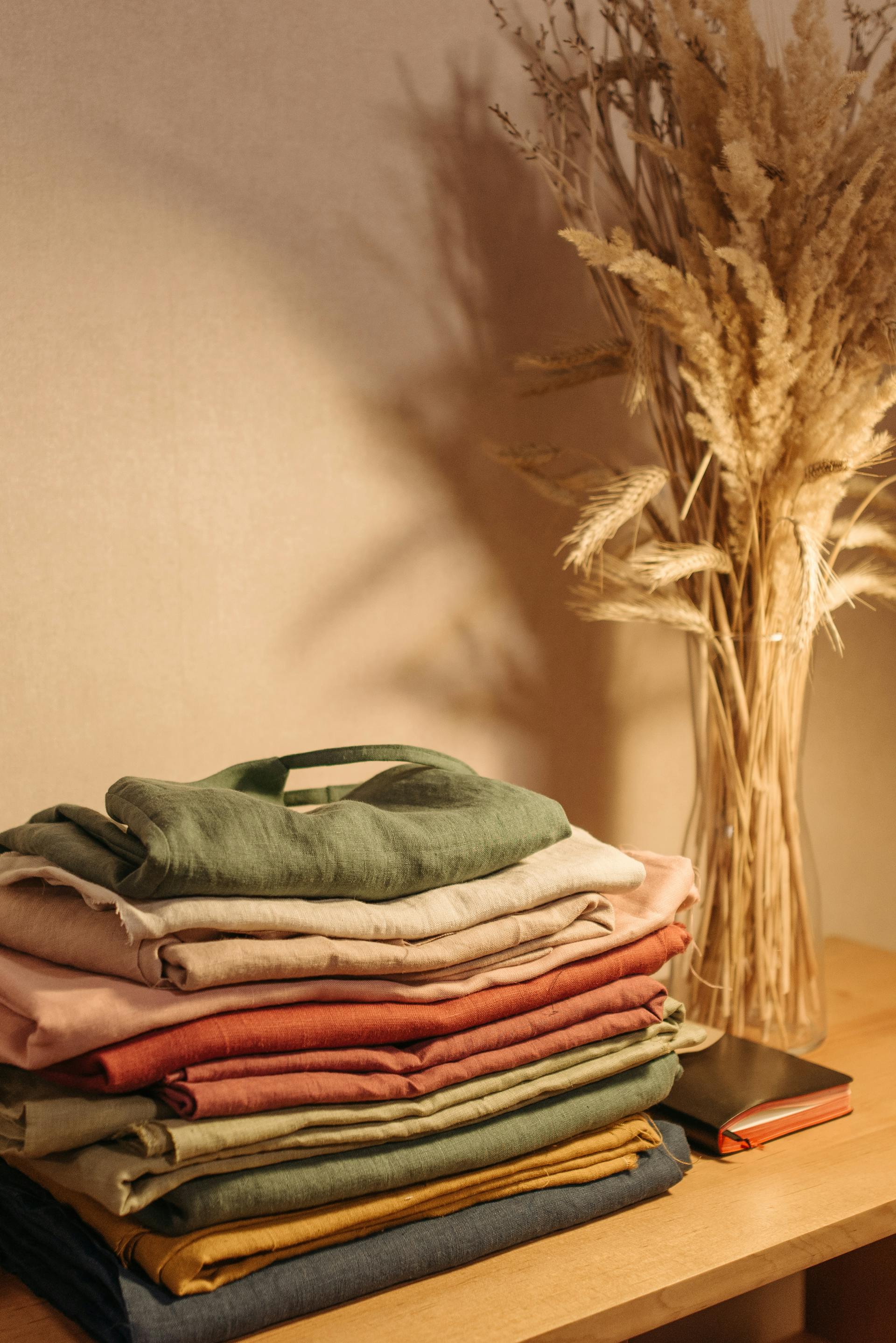 A stack of folded clothes on a hallway table | Source: Pexels