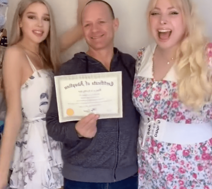 A father stands with his biological trans daughter and her trans best friend who he has symbolically adopted | Photo: TikTok/grace.hylandd