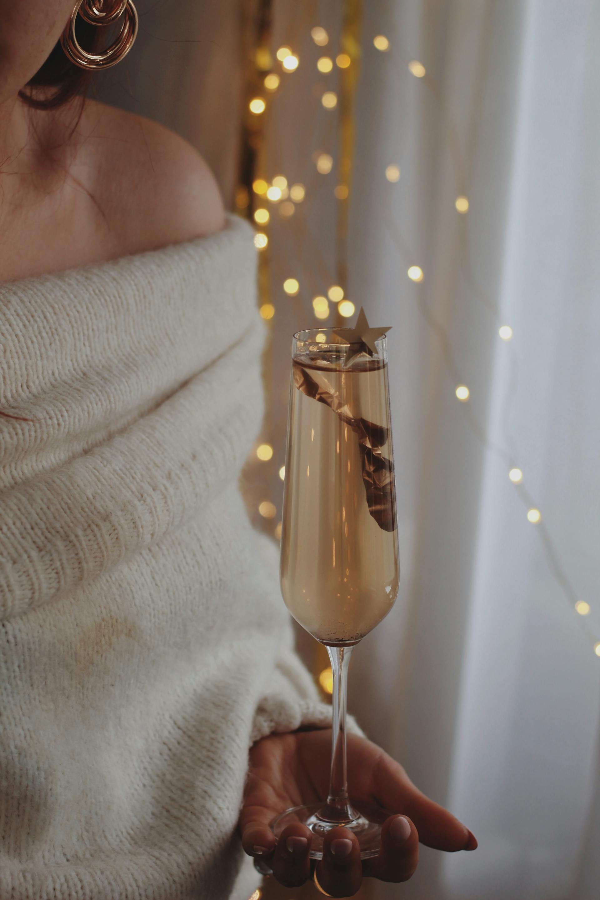 A woman holding a glass of champagne | Source: Pexels
