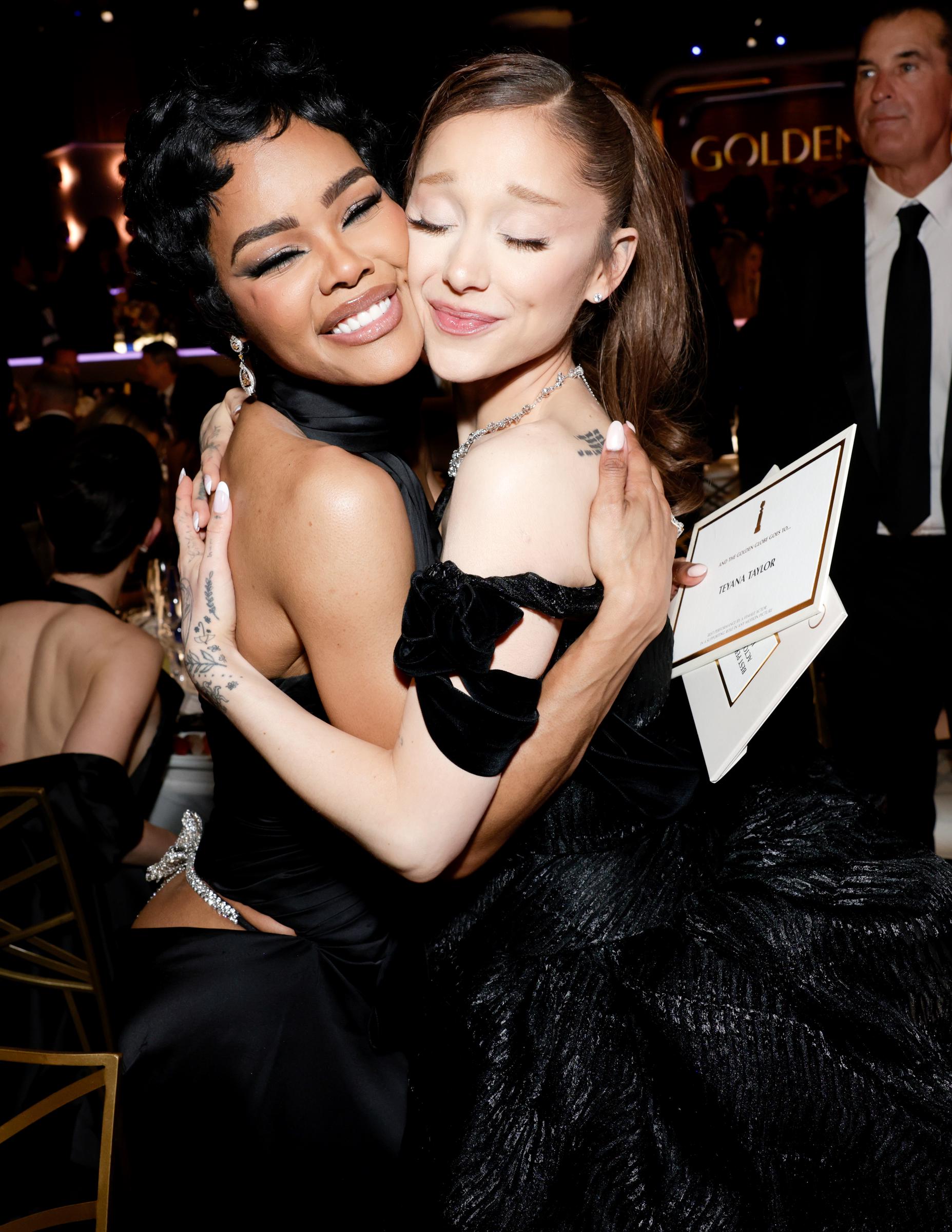 Teyana Taylor and Ariana Grande embrace in a joyful hug, celebrating Taylor's historic win in a heartwarming moment of support and sisterhood.