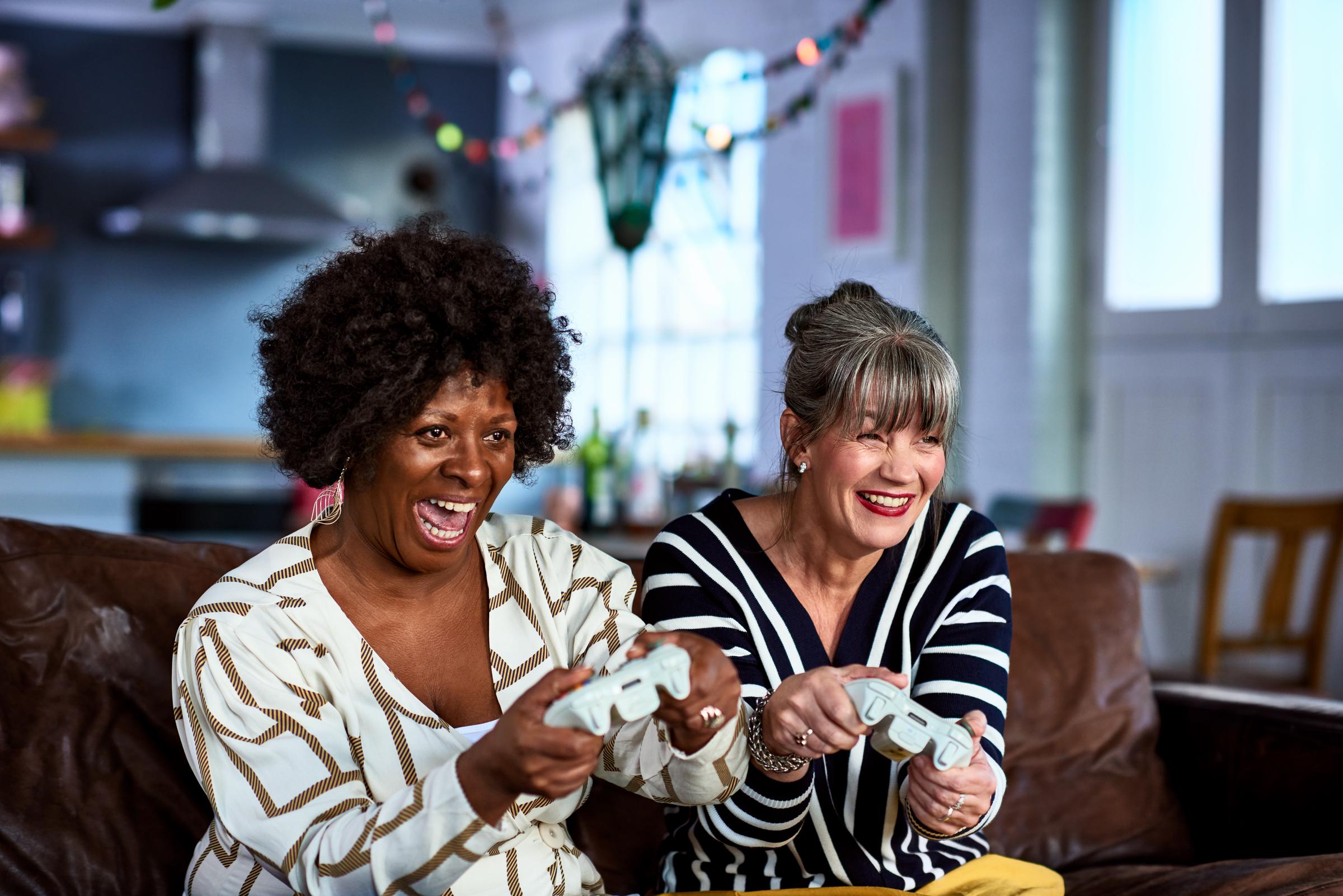 Two women having fun playing video games | Source: Getty Images