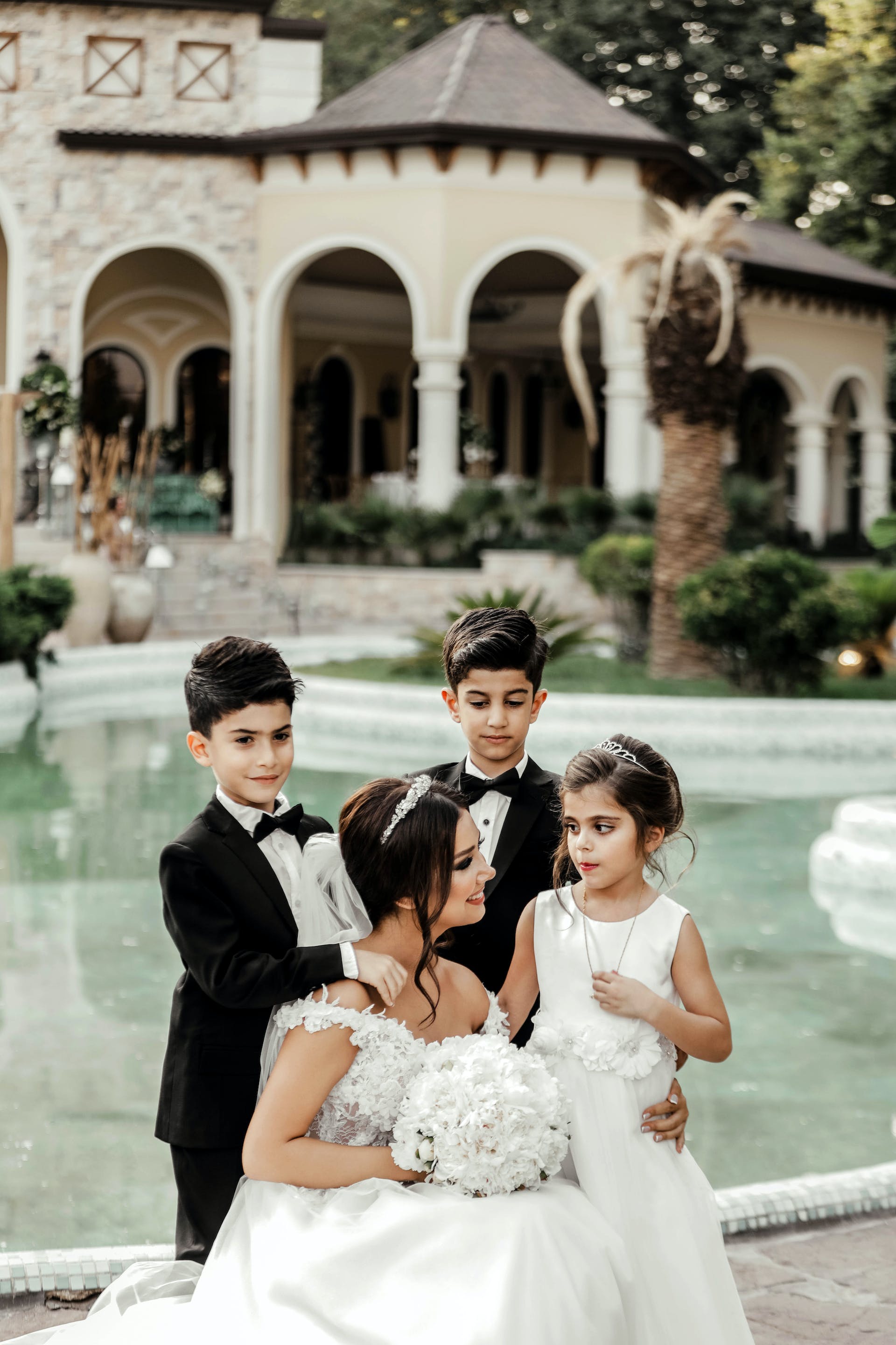 Three children standing around  a bride | Source: Pexels
