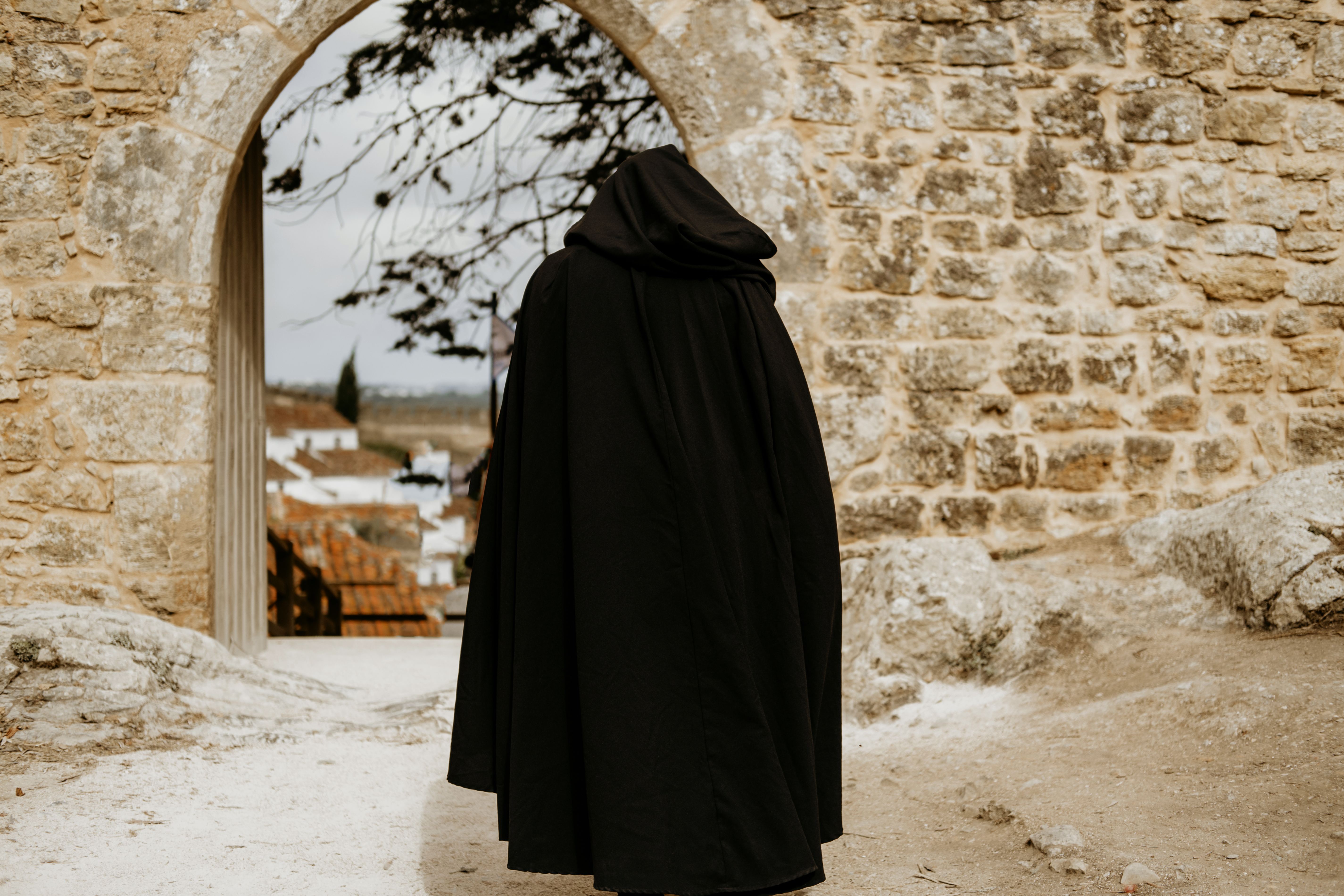 Man wearing long cloak walking on the street | Source: Shutterstock.com