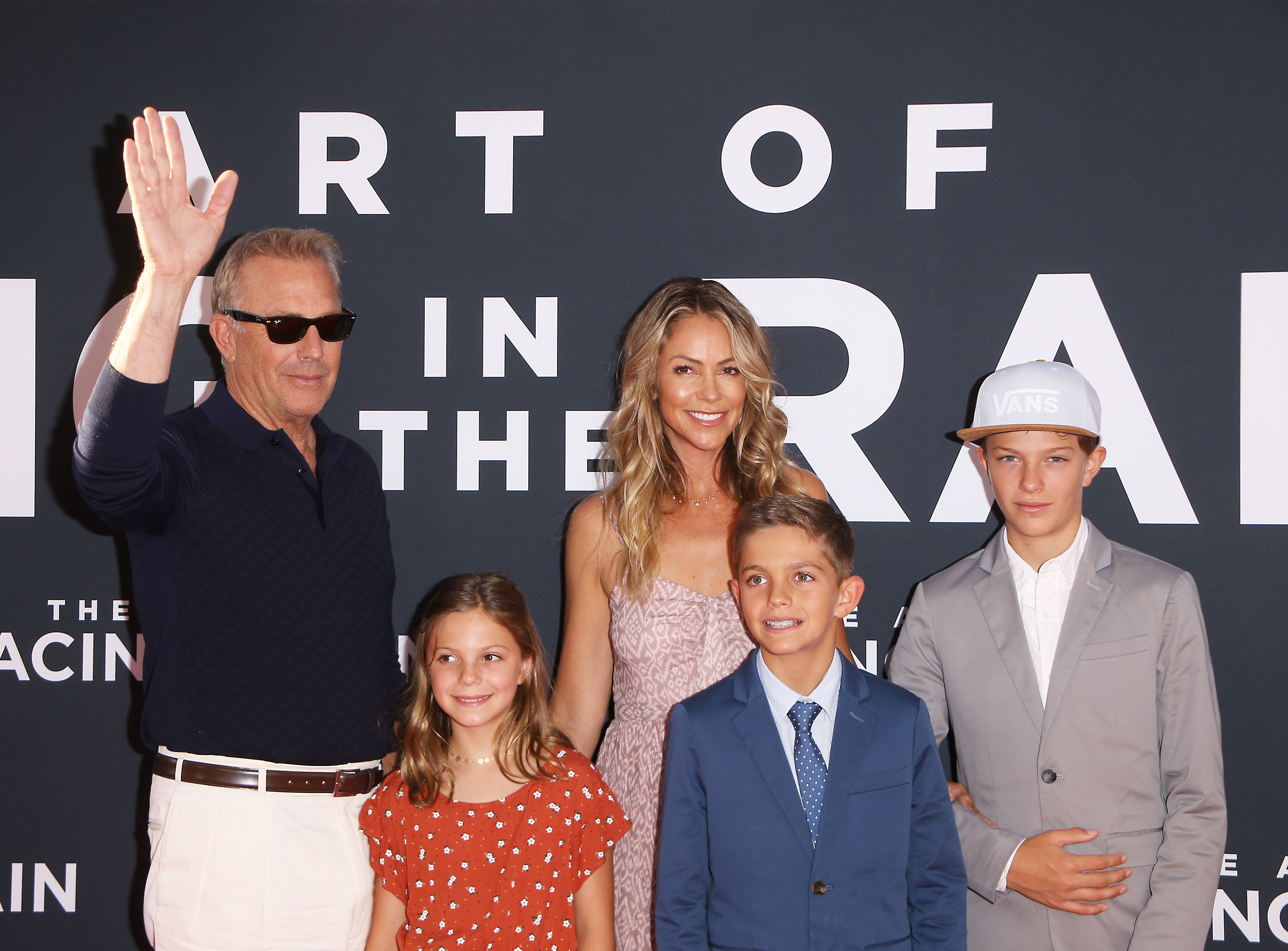 Kevin Costner, Christine Baumgartner and their kits at the Los Angeles premiere of 20th Century Fox's "The Art of Racing In The Rain" held at El Capitan Theatre on August 01, 2019 in Los Angeles, California. | Source: Shutterstock